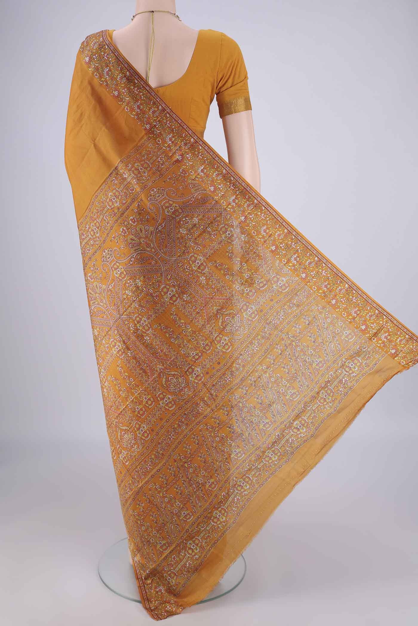 Flat view of Mustard Printed Silk Saree with Plain Body and Printed Border. 