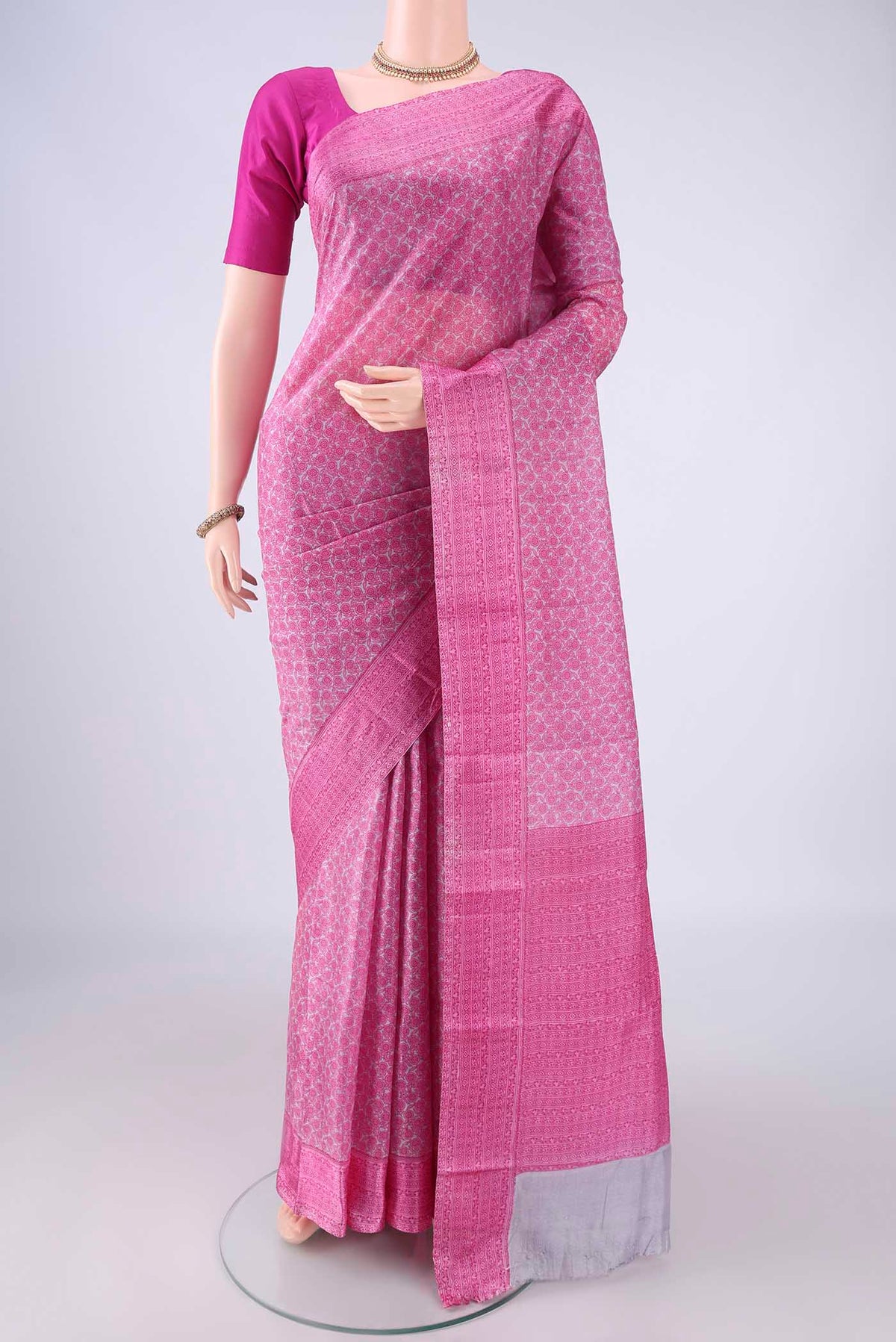Pink Printed Silk Saree with Printed design on the body and Printed Border.  displayed on a mannequin