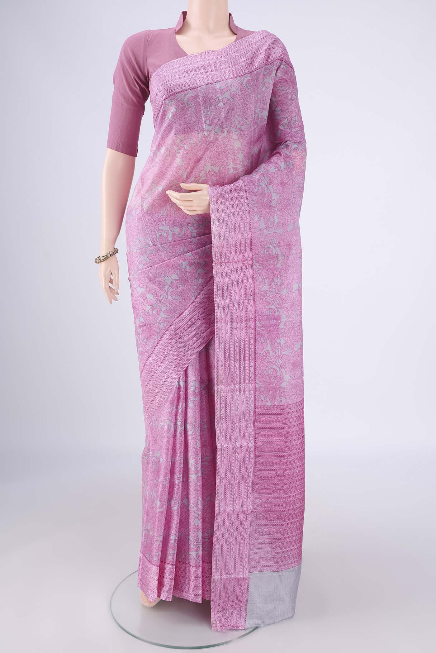 Grey Printed Silk Saree with Printed design on the body and Printed Border.  displayed on a mannequin