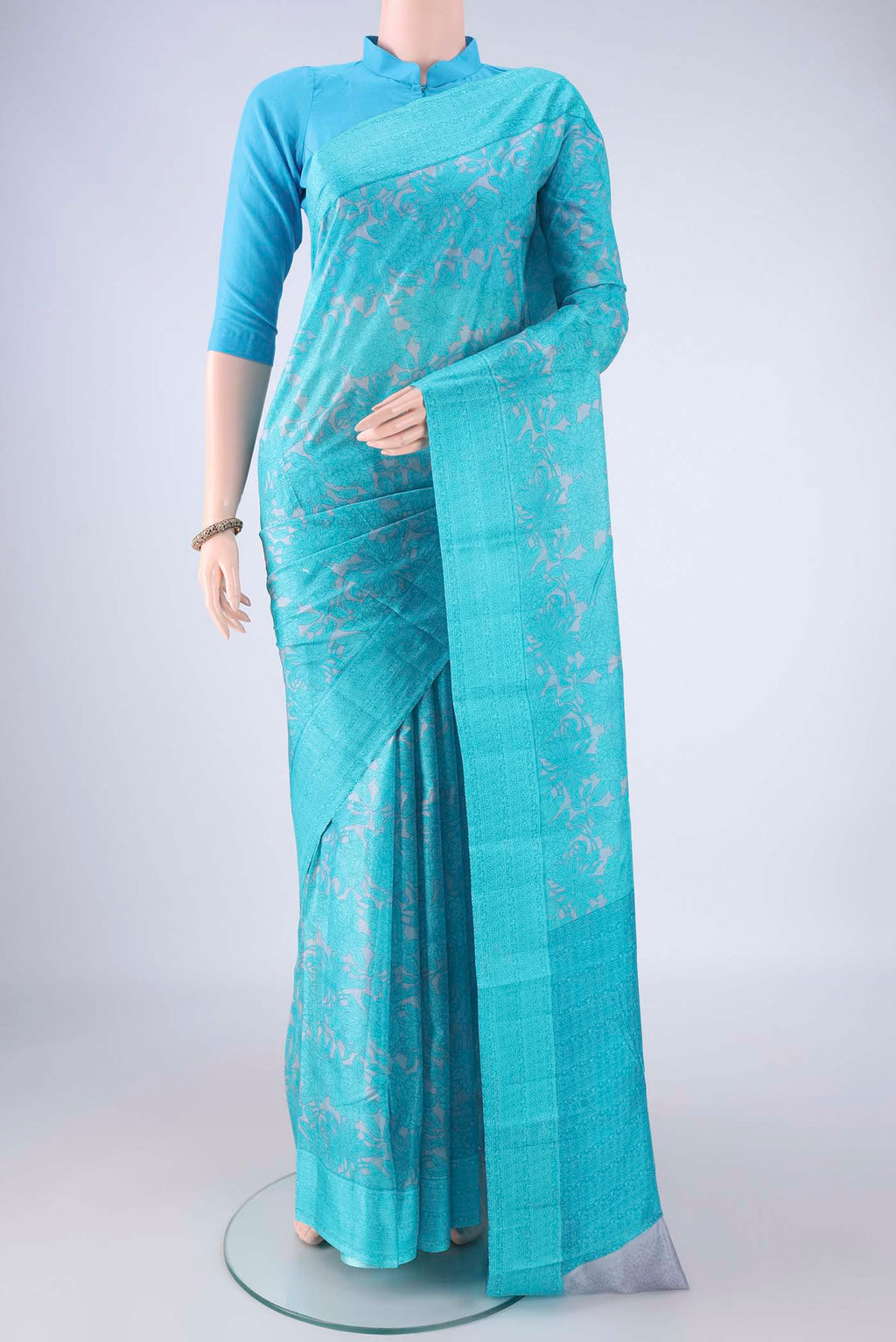 Grey Printed Silk Saree with Printed design on the body and Printed Border.  displayed on a mannequin