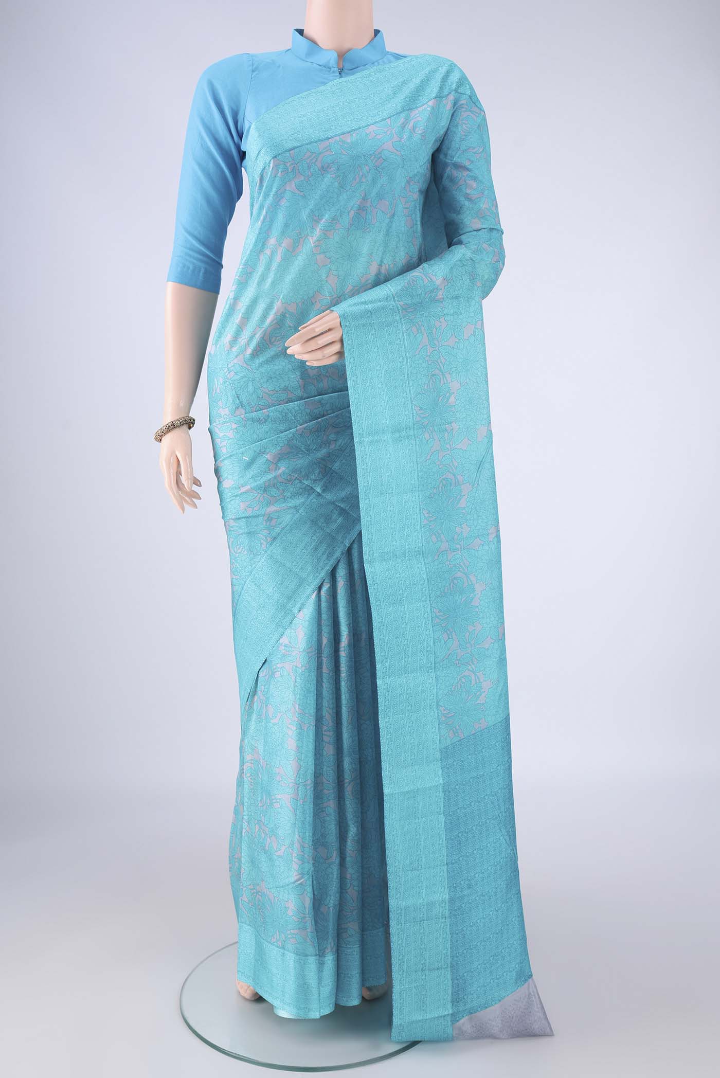 Grey Printed Silk Saree with Printed design on the body and Printed Border.  displayed on a mannequin