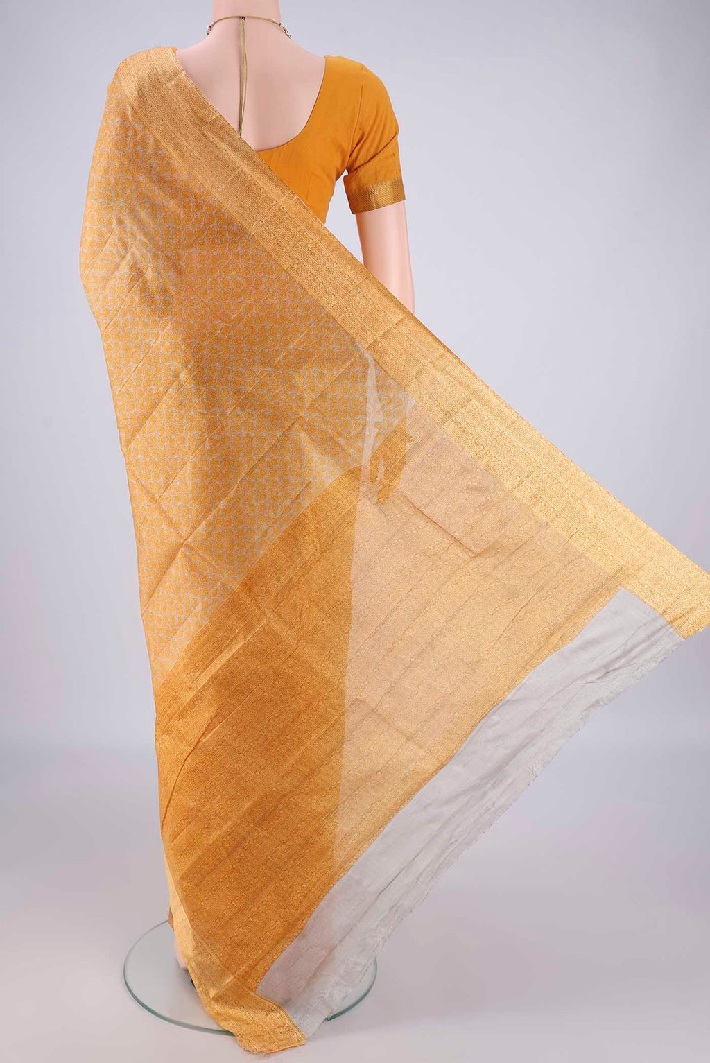 Flat view of Beige Printed Silk Saree with Printed design on the body and Zari Border. 