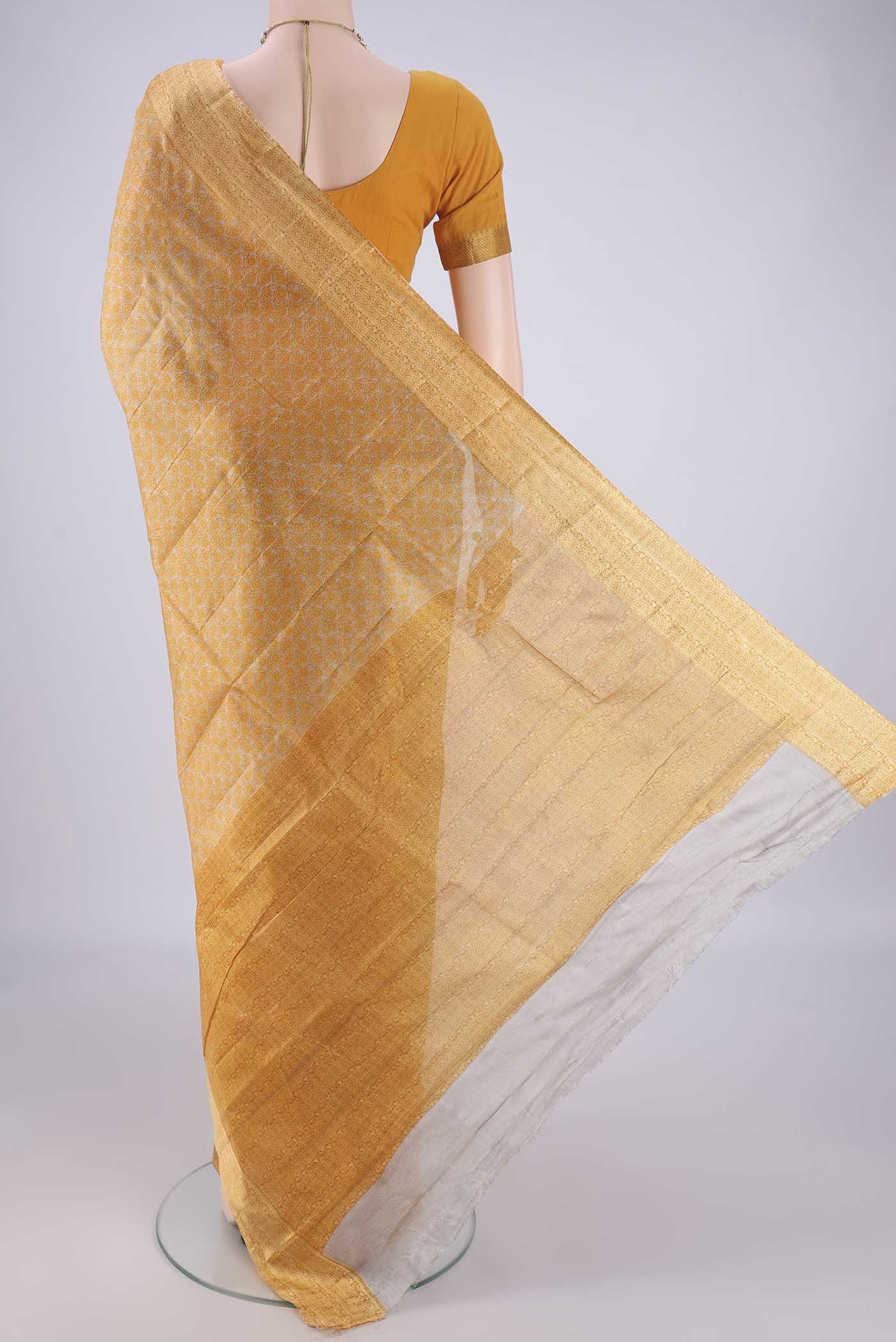 Flat view of Beige Printed Silk Saree with Printed design on the body and Zari Border. 