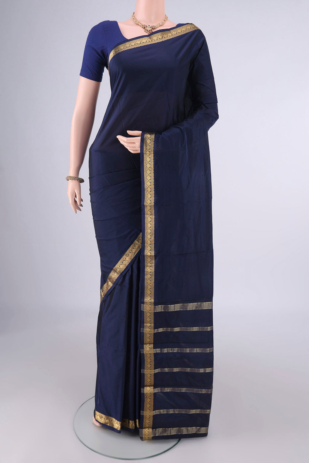 Navy Blue Blended Bangalore Silk Saree with Plain Body and Zari Border.  displayed on a mannequin