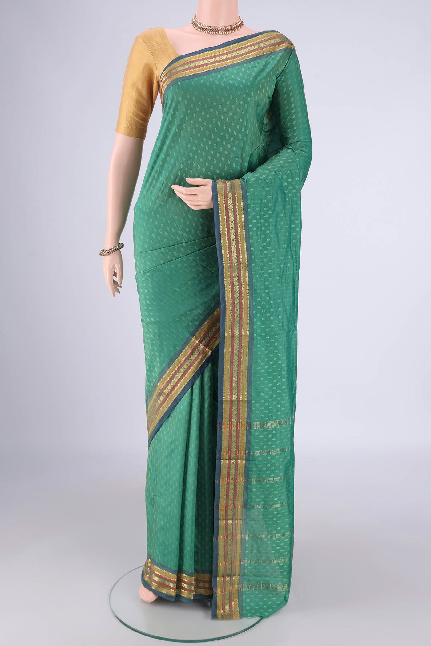 Light Green Blended Bangalore Silk Saree with Jacquard design on the body and Plain Border.  displayed on a mannequin