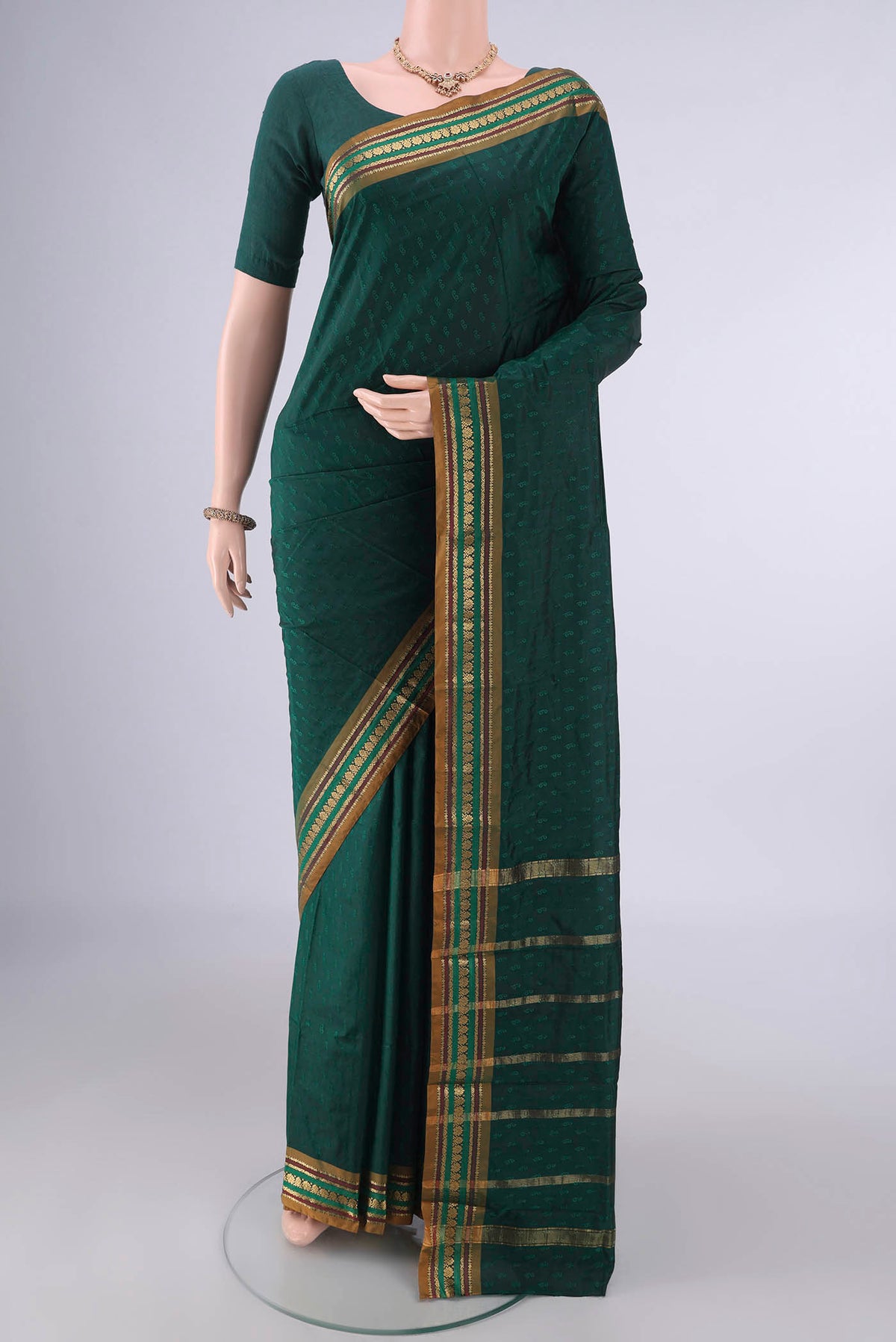 Bottle Green Blended Bangalore Silk Saree with Jacquard design on the body and Zari Border.  displayed on a mannequin