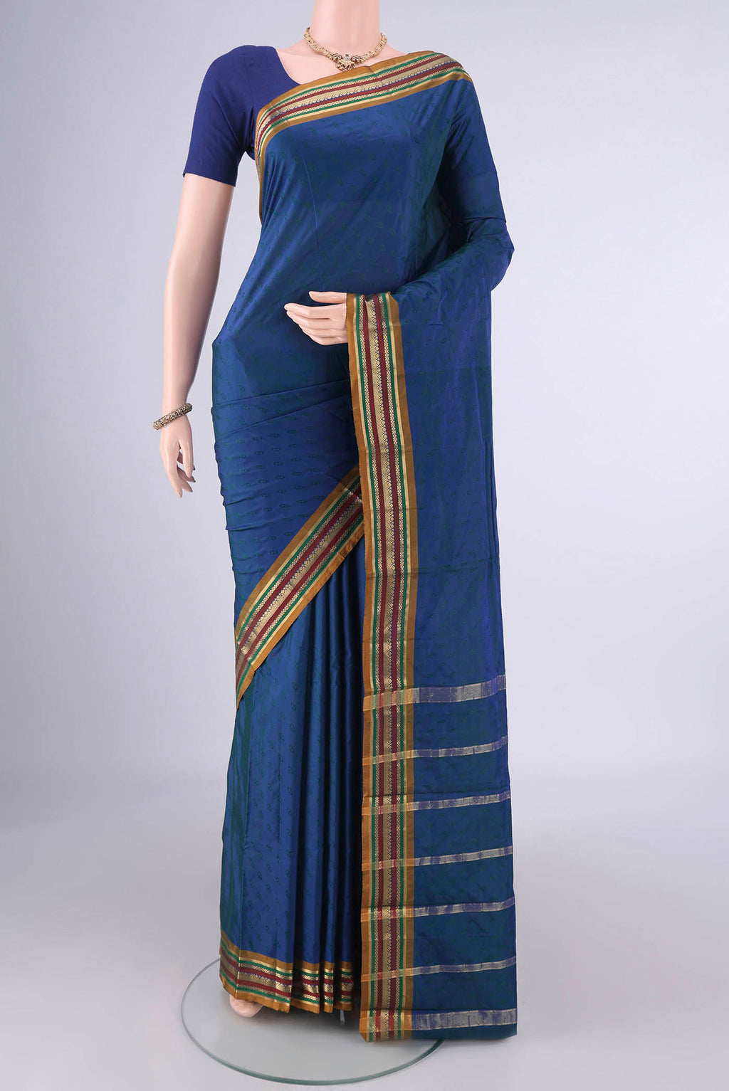 Peacock Blue Blended Bangalore Silk Saree with Jacquard design on the body and Zari Border.  displayed on a mannequin