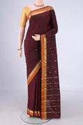 Maroon Blended Bangalore Silk Saree with Zari Butta on the body and Plain Border.  displayed on a mannequin