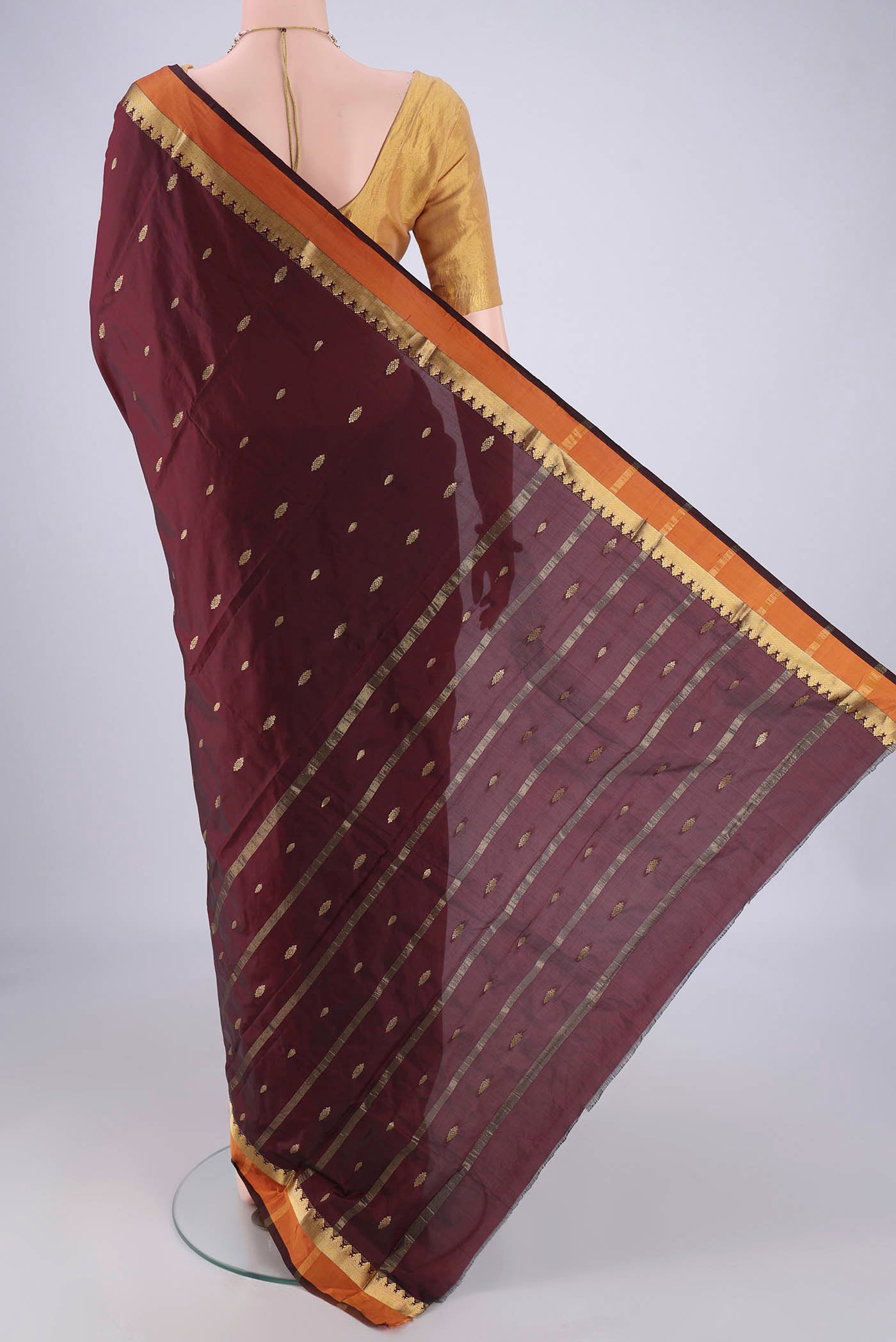 Flat view of Maroon Blended Bangalore Silk Saree with Zari Butta on the body and Plain Border. 