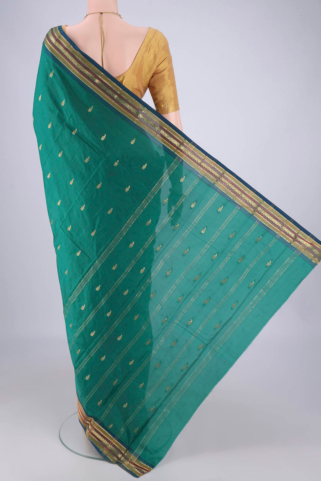 Flat view of Green Blended Bangalore Silk Saree with Zari Butta on the body and Plain Border. 