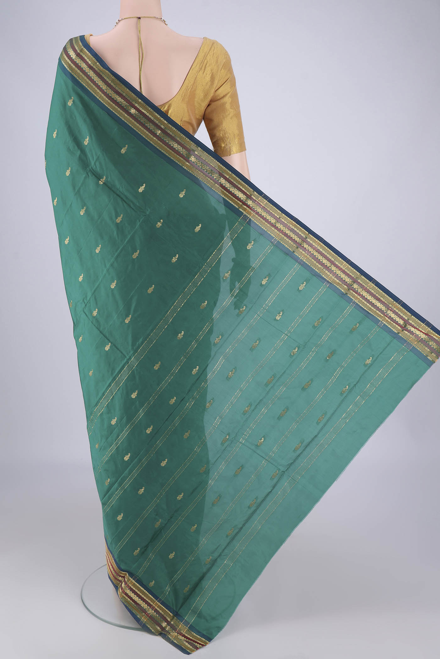 Flat view of Green Blended Bangalore Silk Saree with Zari Butta on the body and Plain Border. 