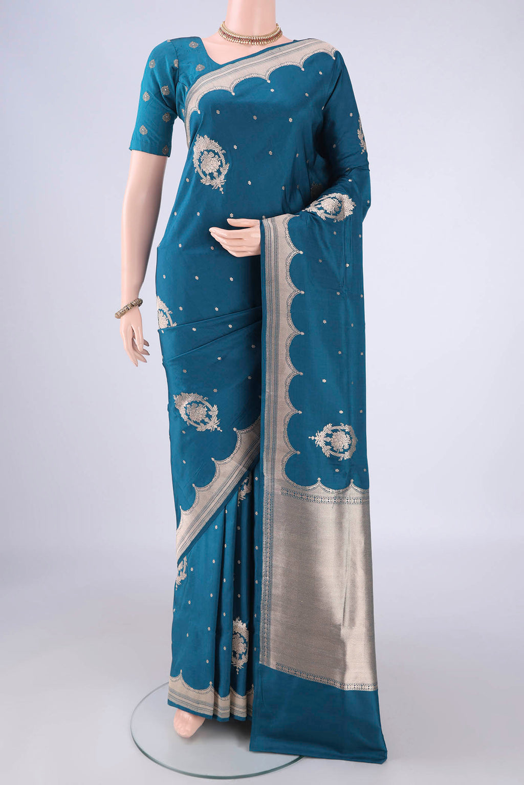 Peacock Blue Banarasi Silk Saree with Zari Butta on the body and Zari Border.  displayed on a mannequin