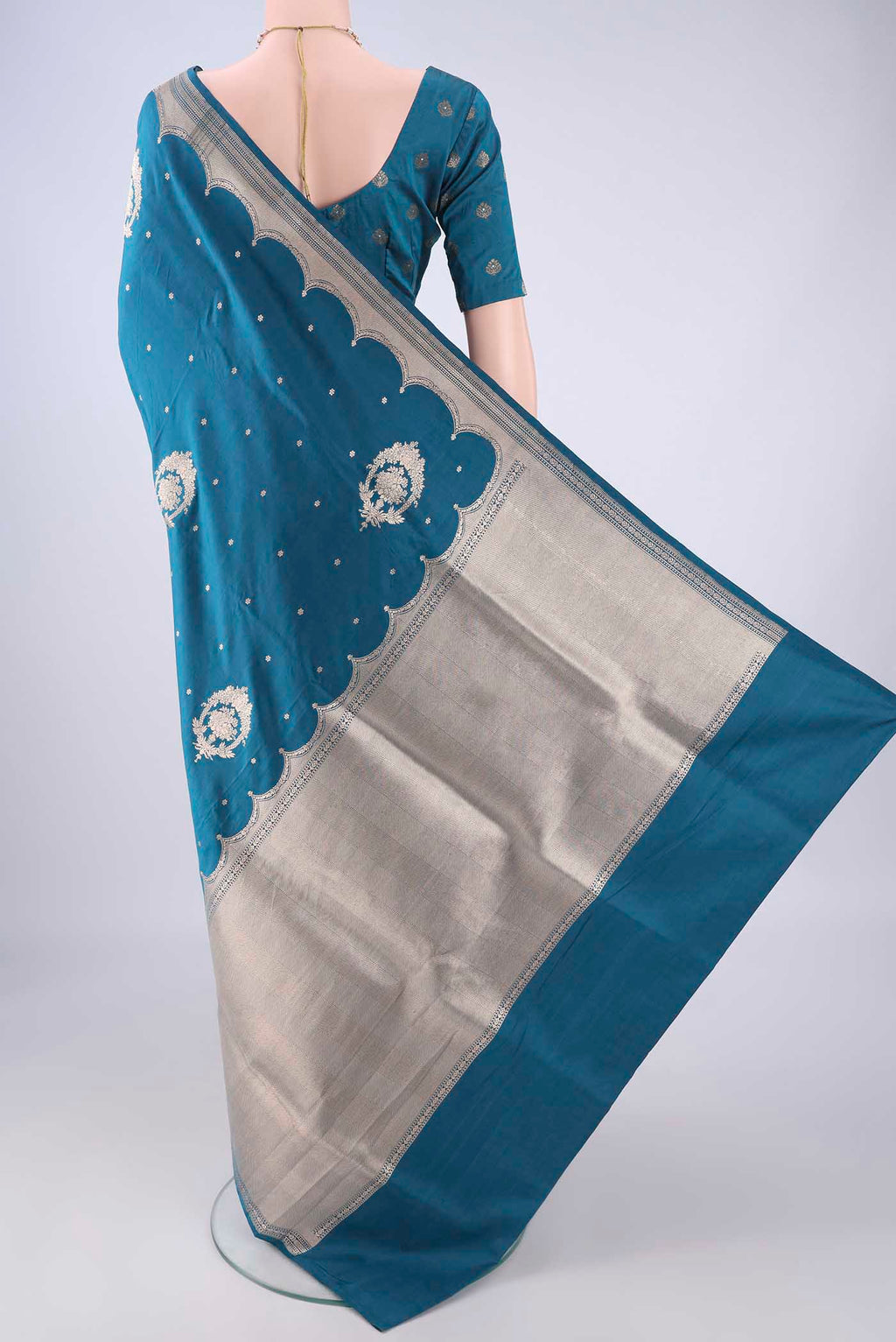 Flat view of Peacock Blue Banarasi Silk Saree with Zari Butta on the body and Zari Border. 
