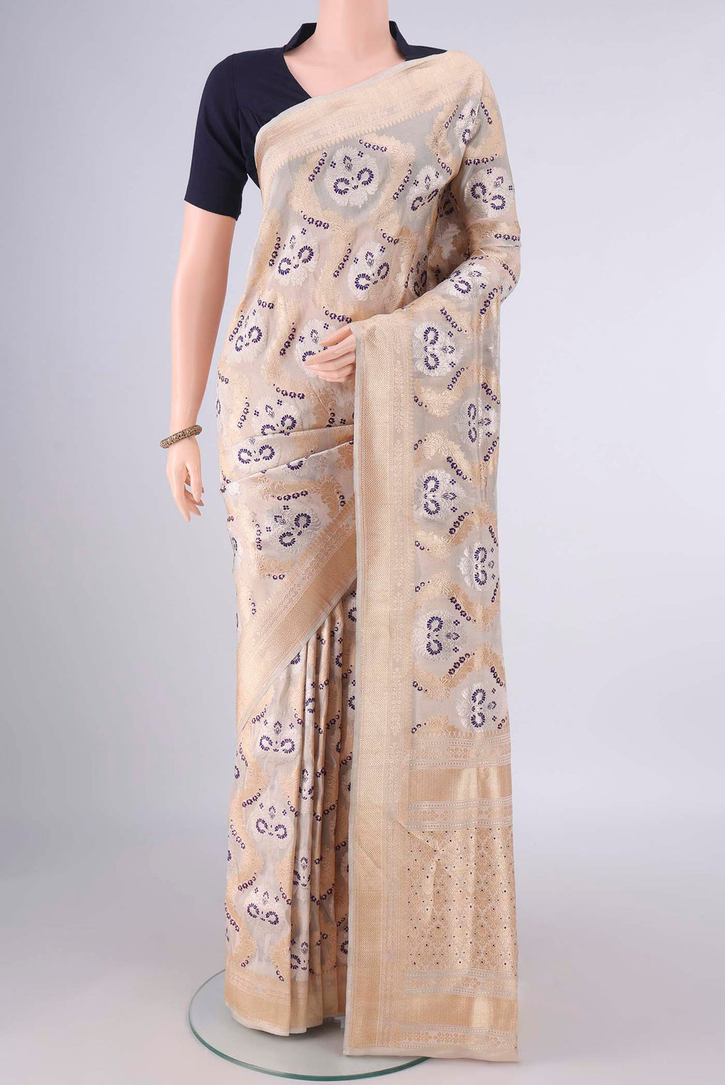 Pure Silk Sandal Banarasi Saree with Zari Brocade on the body and Zari Border.  displayed on a mannequin