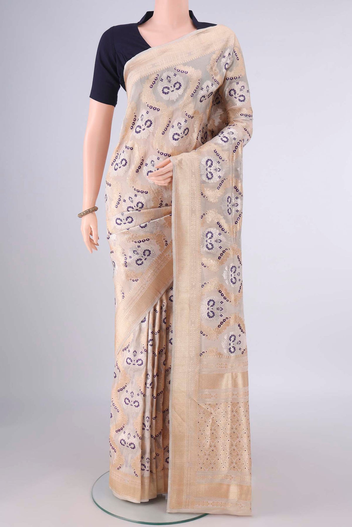 Pure Silk Sandal Banarasi Saree with Zari Brocade on the body and Zari Border.  displayed on a mannequin