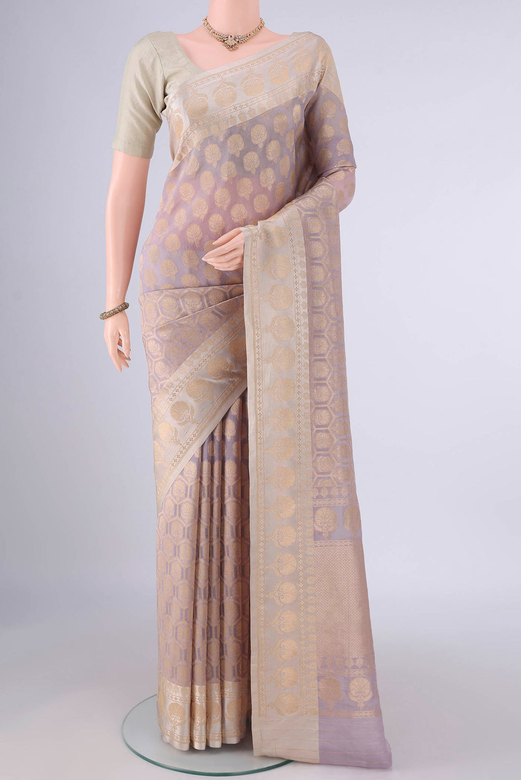 Pure Silk Mauve Banarasi Saree with Zari Butta on the body and Zari Border.  displayed on a mannequin