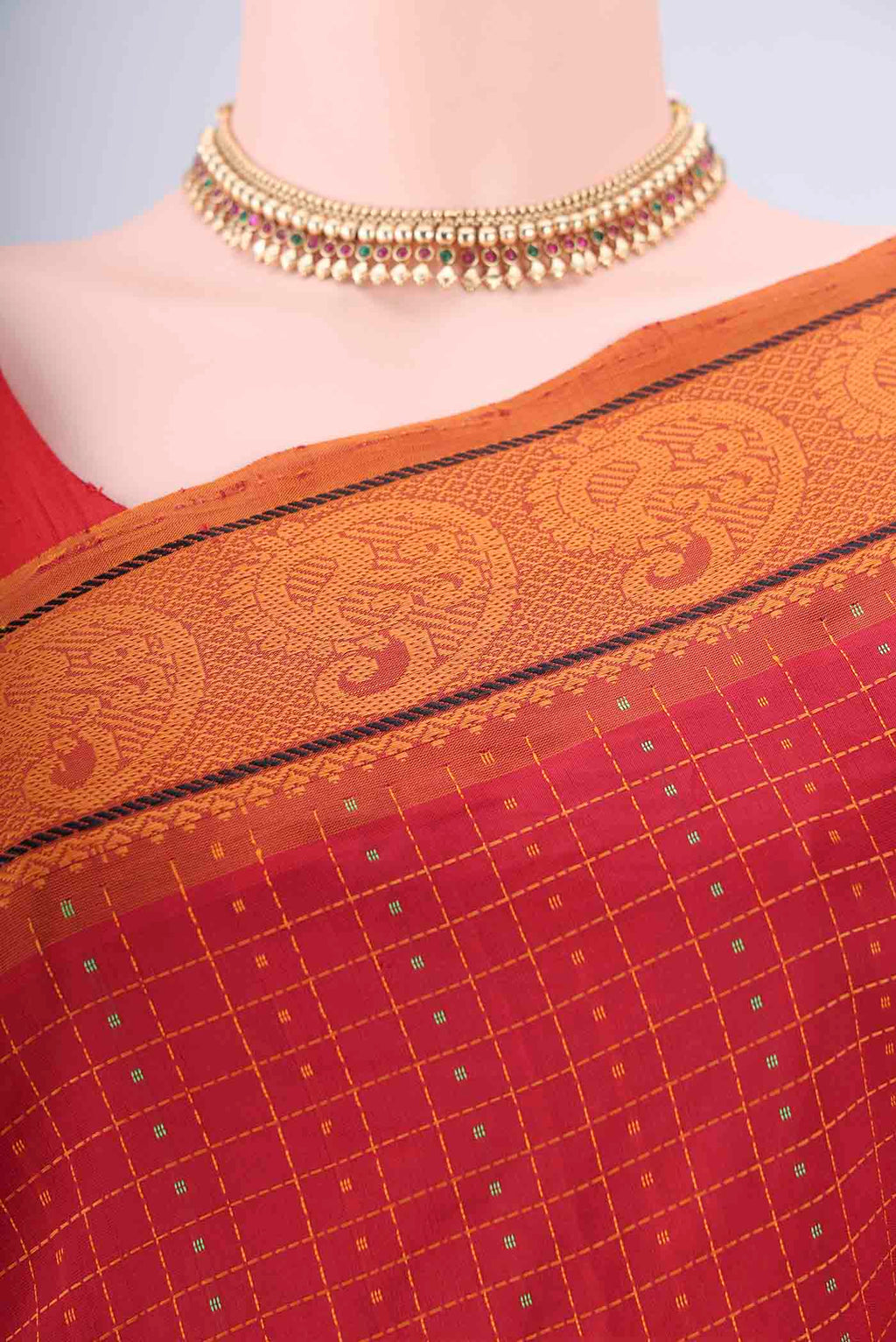 Border image of Red Blended Poly Cotton Saree with Checked design on the body and Thread Border. 