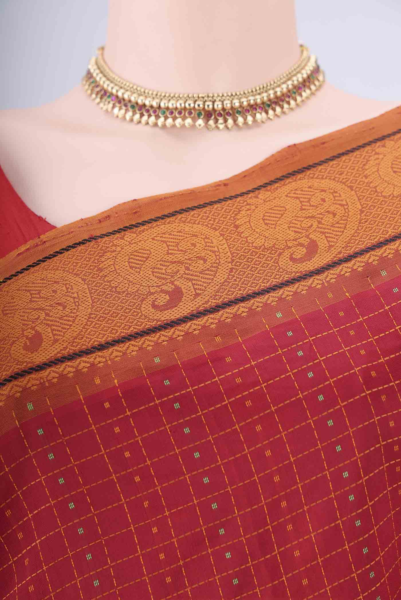 Border image of Red Blended Poly Cotton Saree with Checked design on the body and Thread Border. 