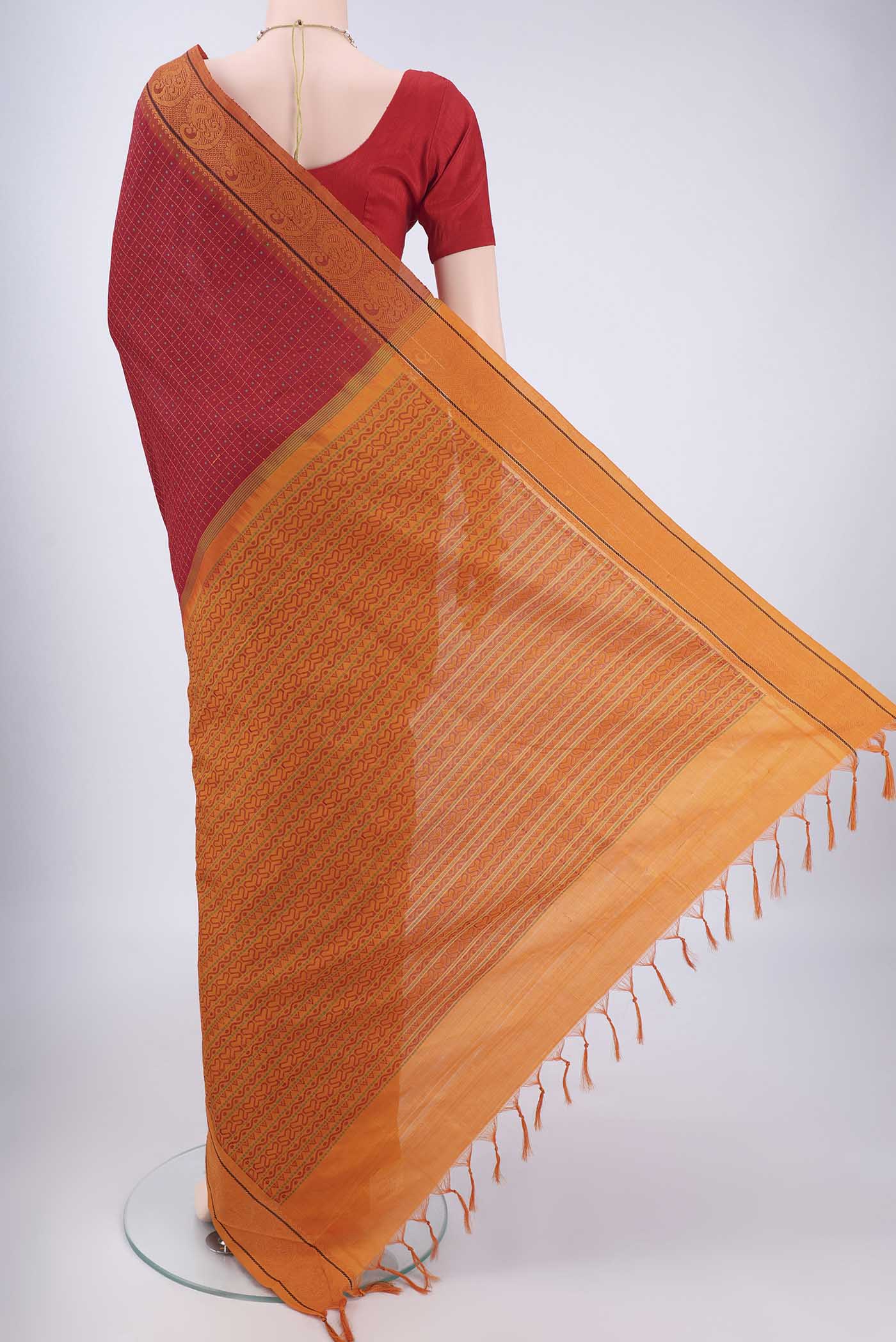 Flat view of Red Blended Poly Cotton Saree with Checked design on the body and Thread Border. 