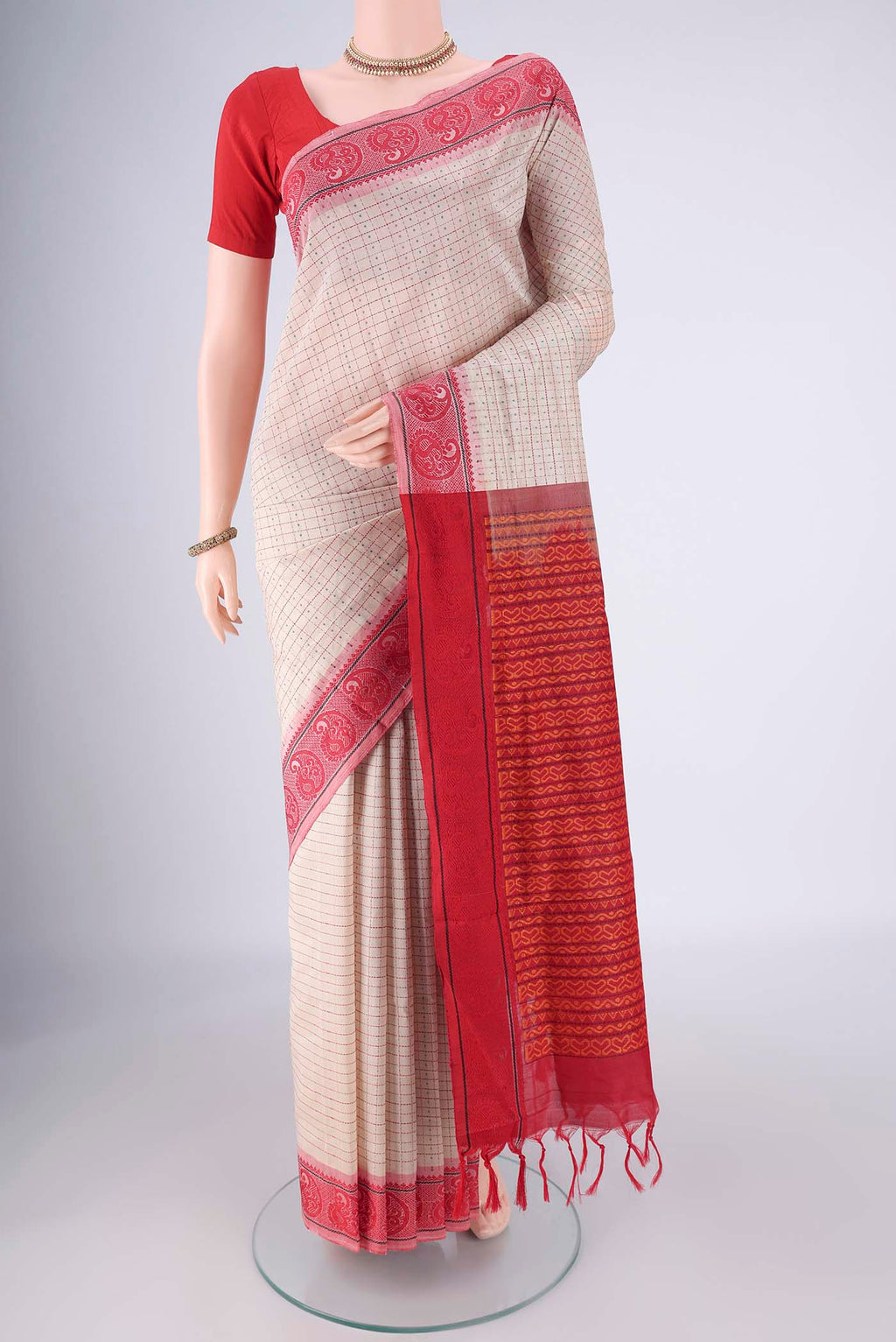 Beige Blended Poly Cotton Saree with Checked design on the body and Thread Border.  displayed on a mannequin