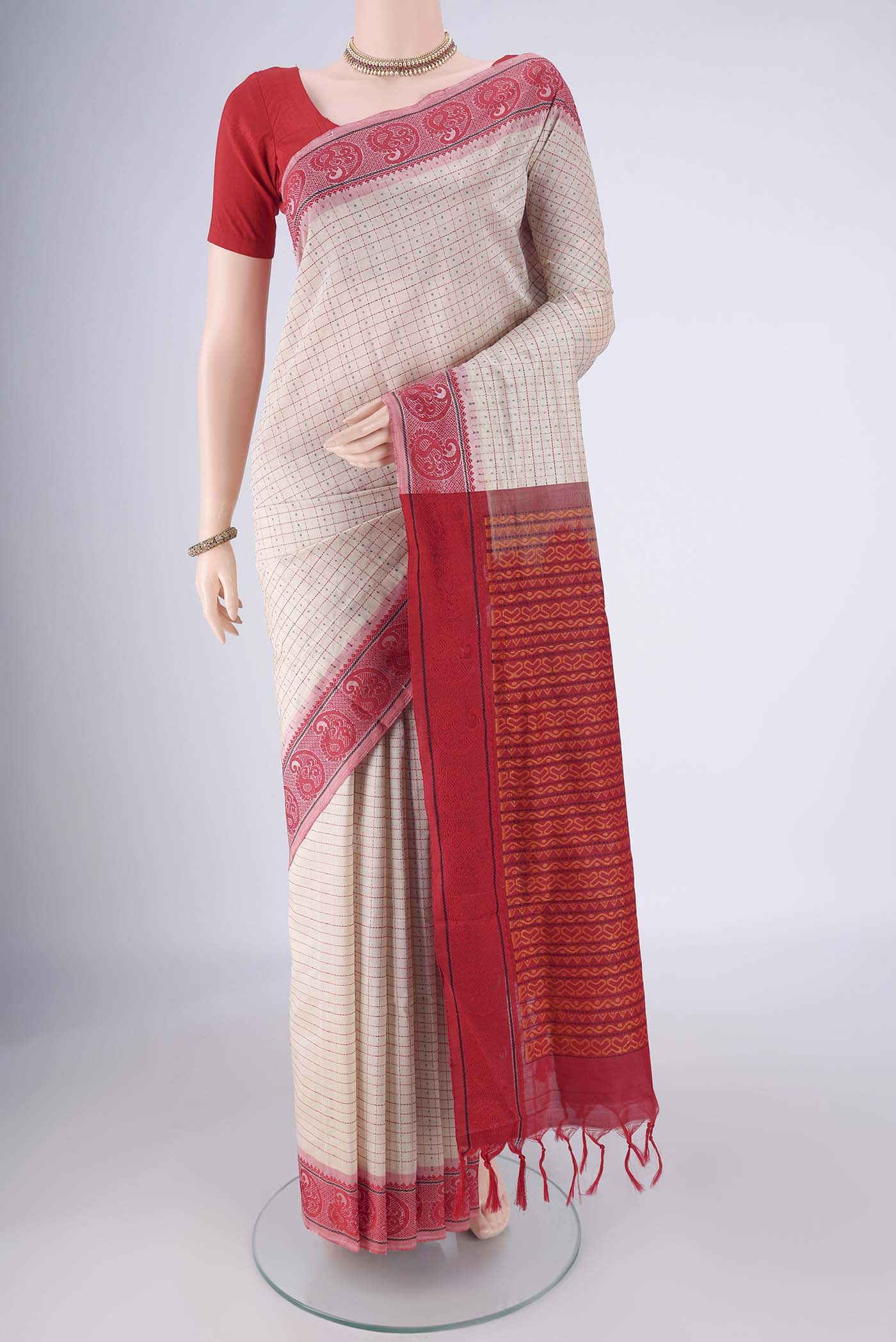 Beige Blended Poly Cotton Saree with Checked design on the body and Thread Border.  displayed on a mannequin