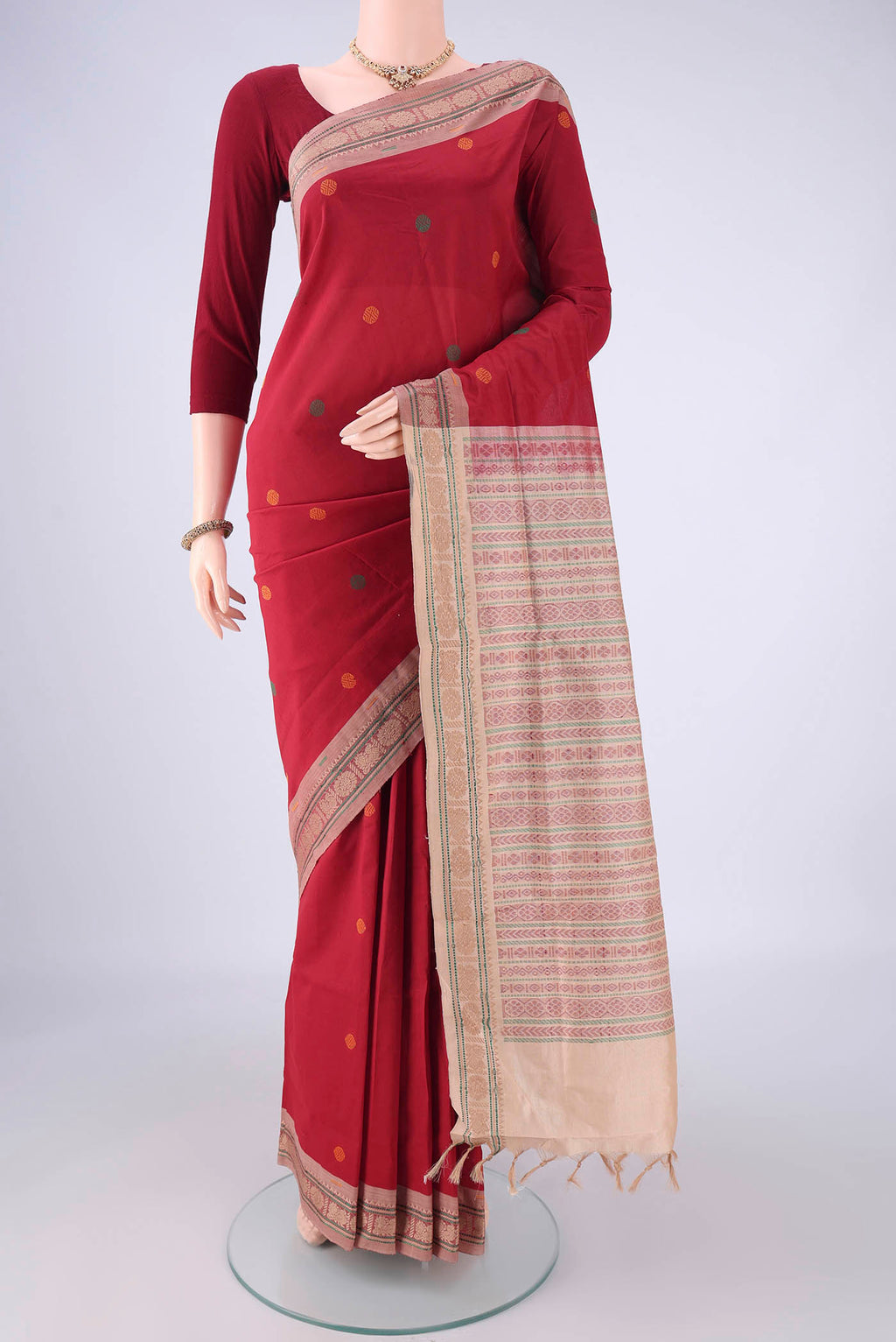 Red Blended Poly Cotton Saree with Thread Butta on the body and Thread Border.  displayed on a mannequin
