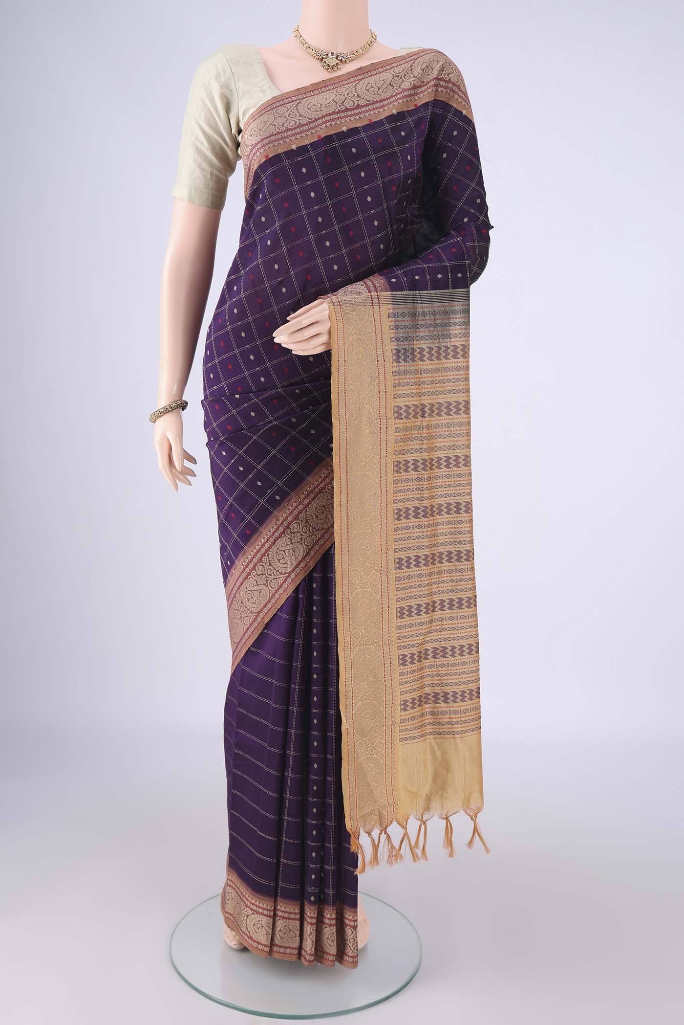 Purple Blended Poly Cotton Saree with Checked design on the body and Thread Border.  displayed on a mannequin