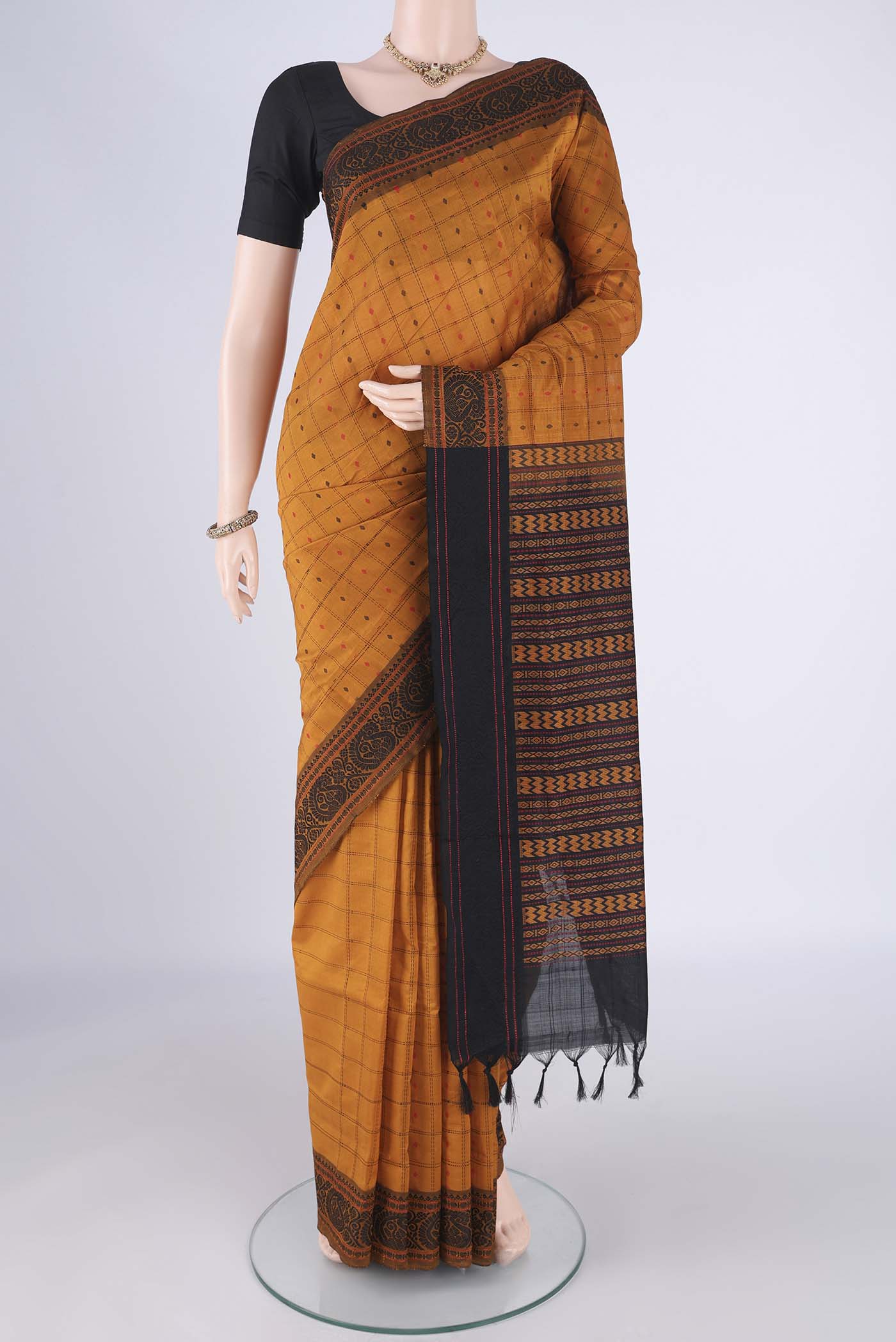 Mustard Blended Poly Cotton Saree with Checked design on the body and Thread Border.  displayed on a mannequin