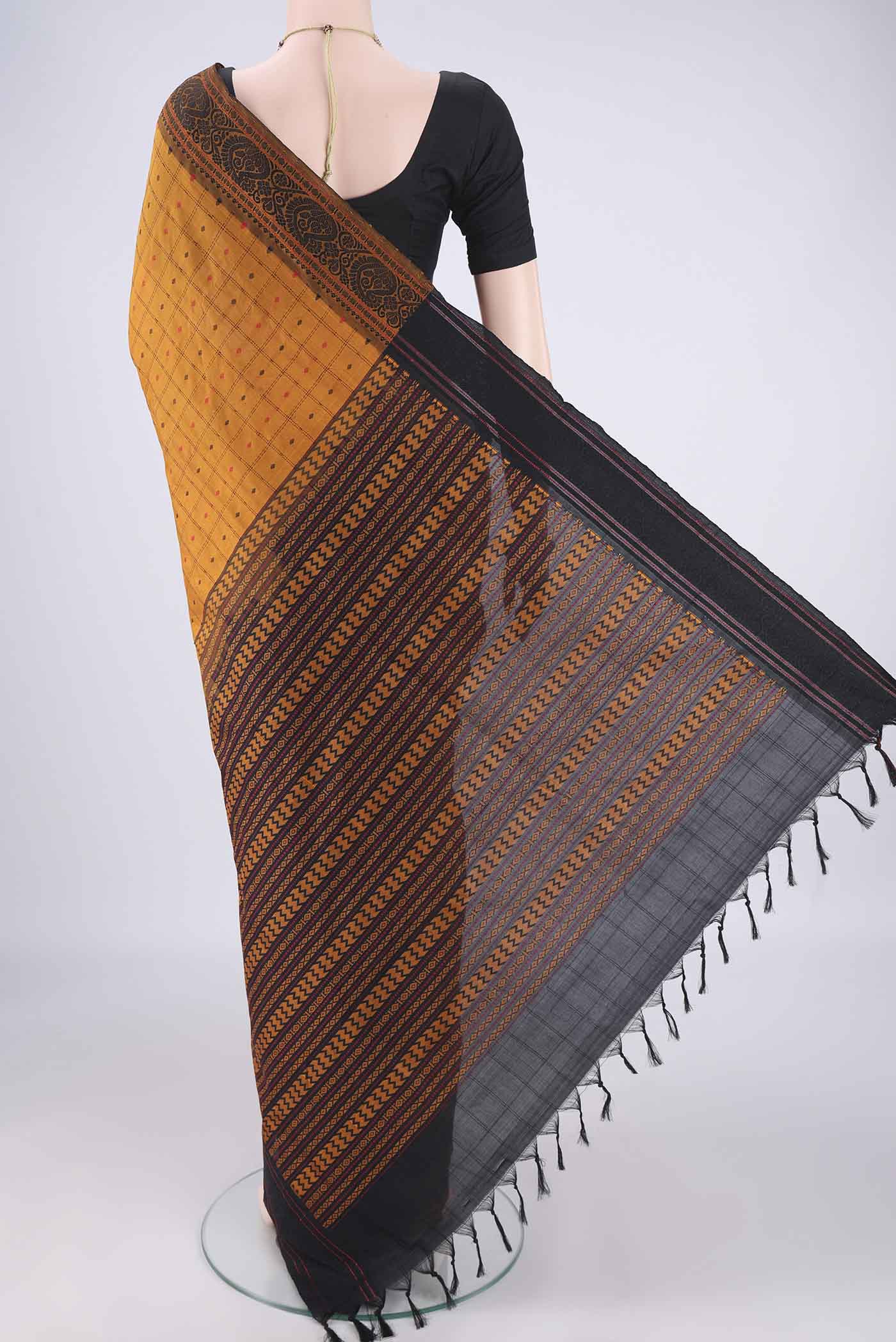 Flat view of Mustard Blended Poly Cotton Saree with Checked design on the body and Thread Border. 