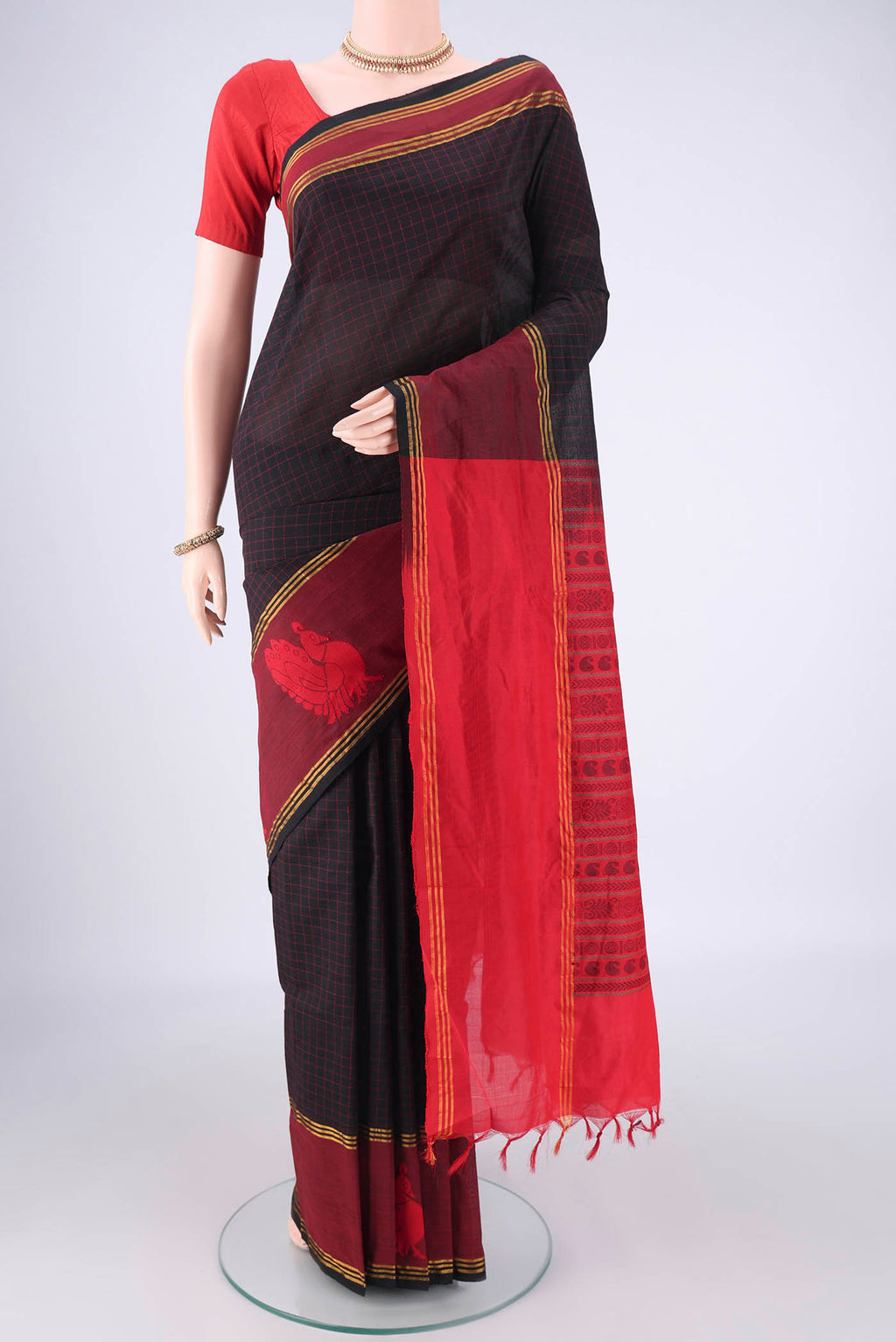 Black Blended Poly Cotton Saree with Checked design on the body and Thread Border.  displayed on a mannequin