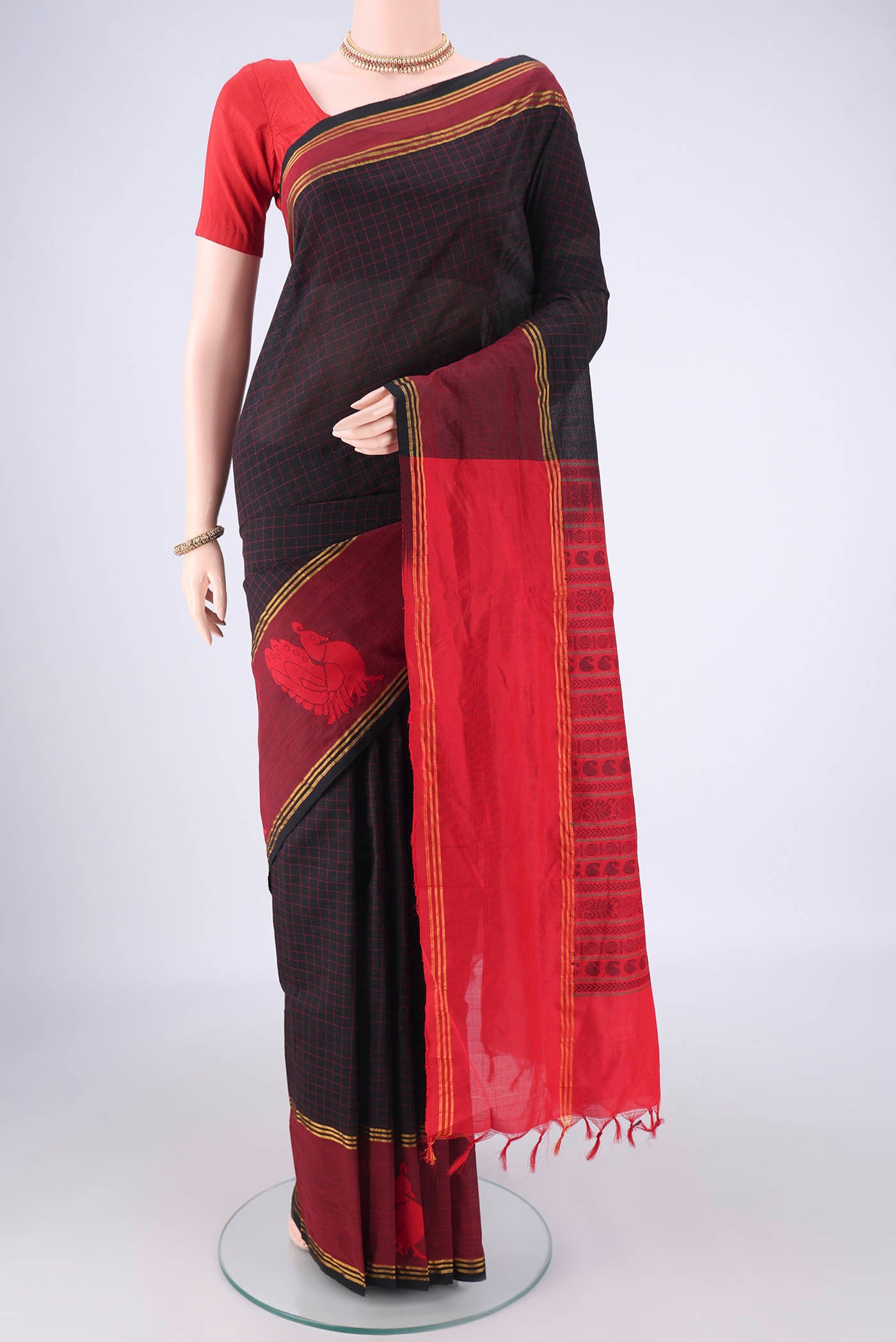 Black Blended Poly Cotton Saree with Checked design on the body and Thread Border.  displayed on a mannequin