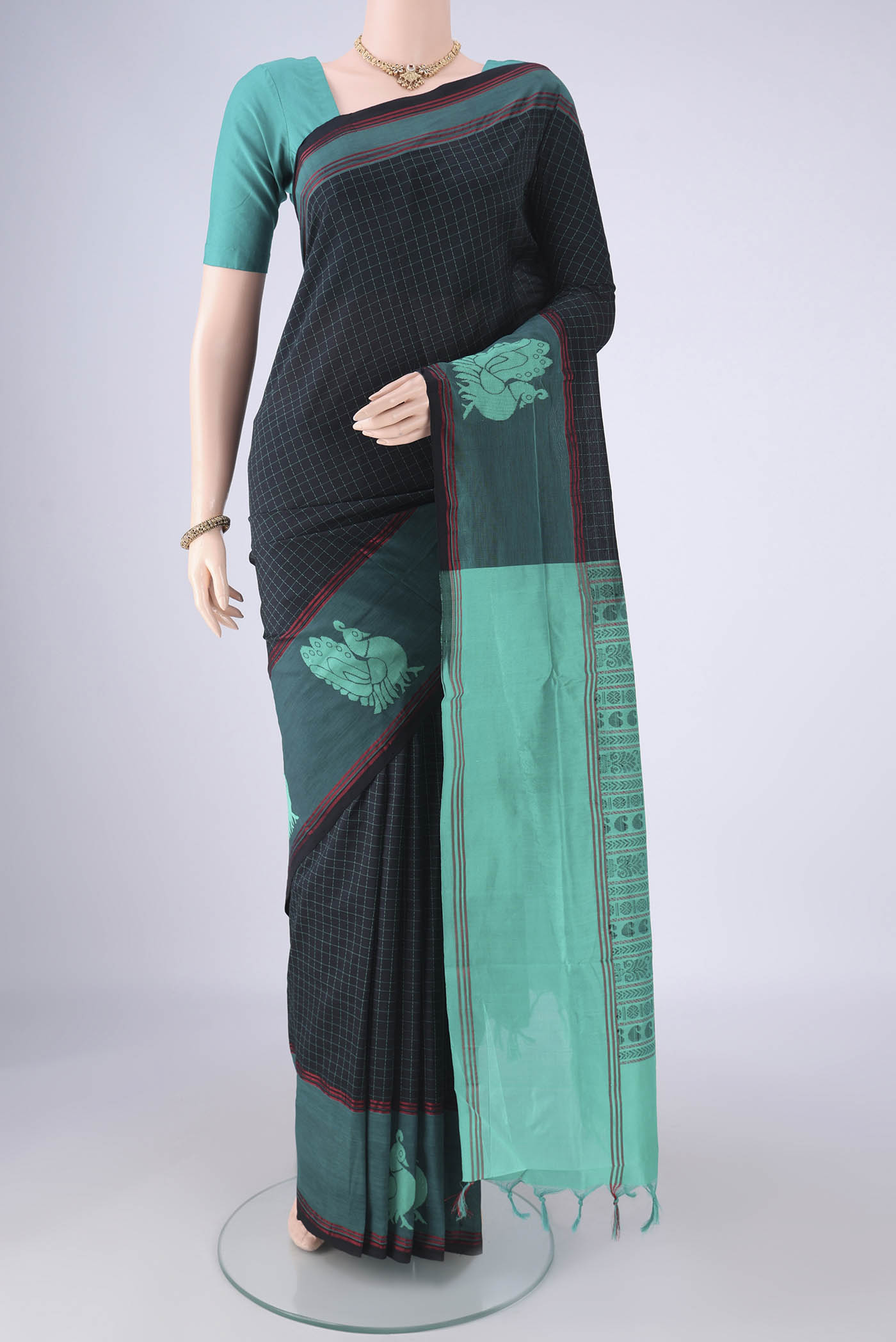 Black Blended Poly Cotton Saree with Checked design on the body and Thread Border.  displayed on a mannequin