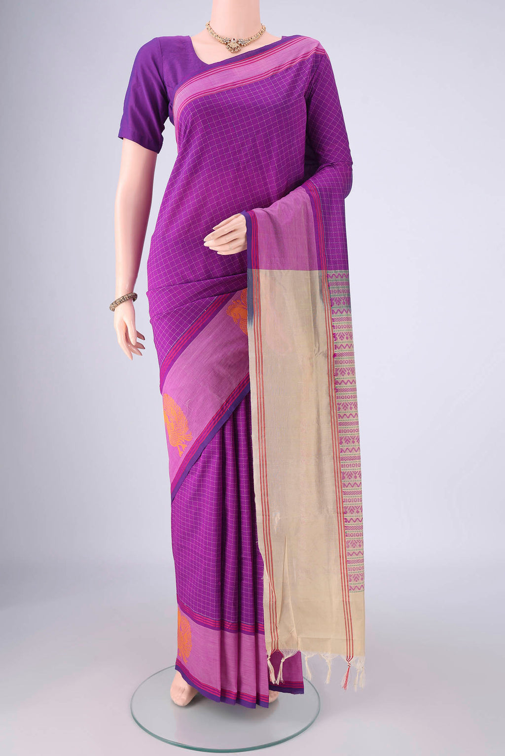 Purple Blended Poly Cotton Saree with Checked design on the body and Plain Border.  displayed on a mannequin