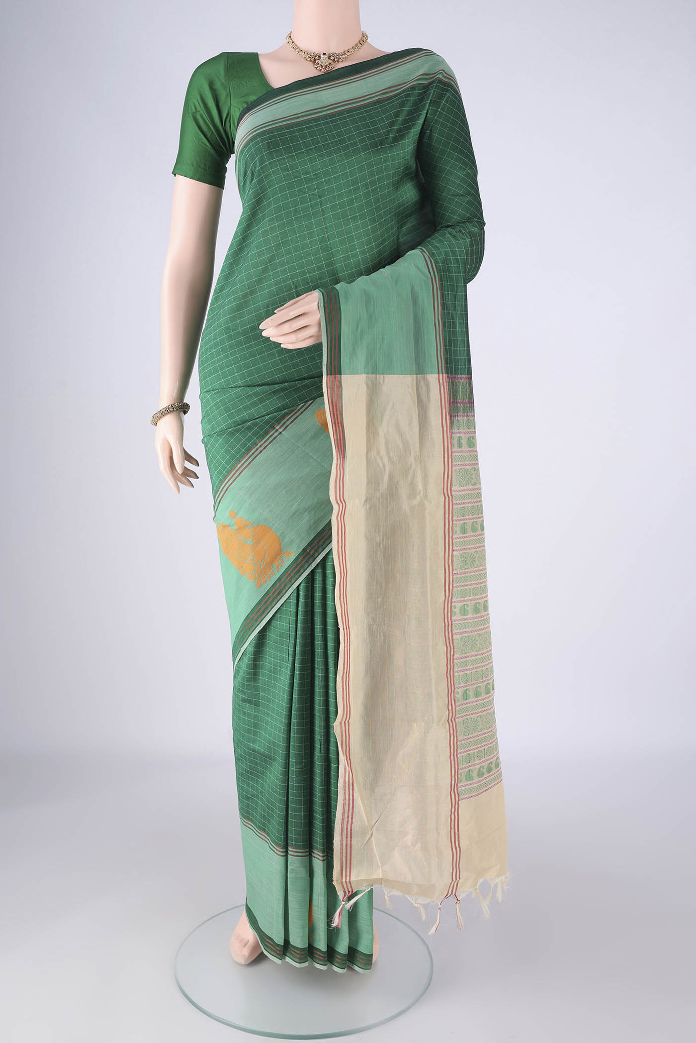 Green Blended Poly Cotton Saree with Checked design on the body and Plain Border.  displayed on a mannequin