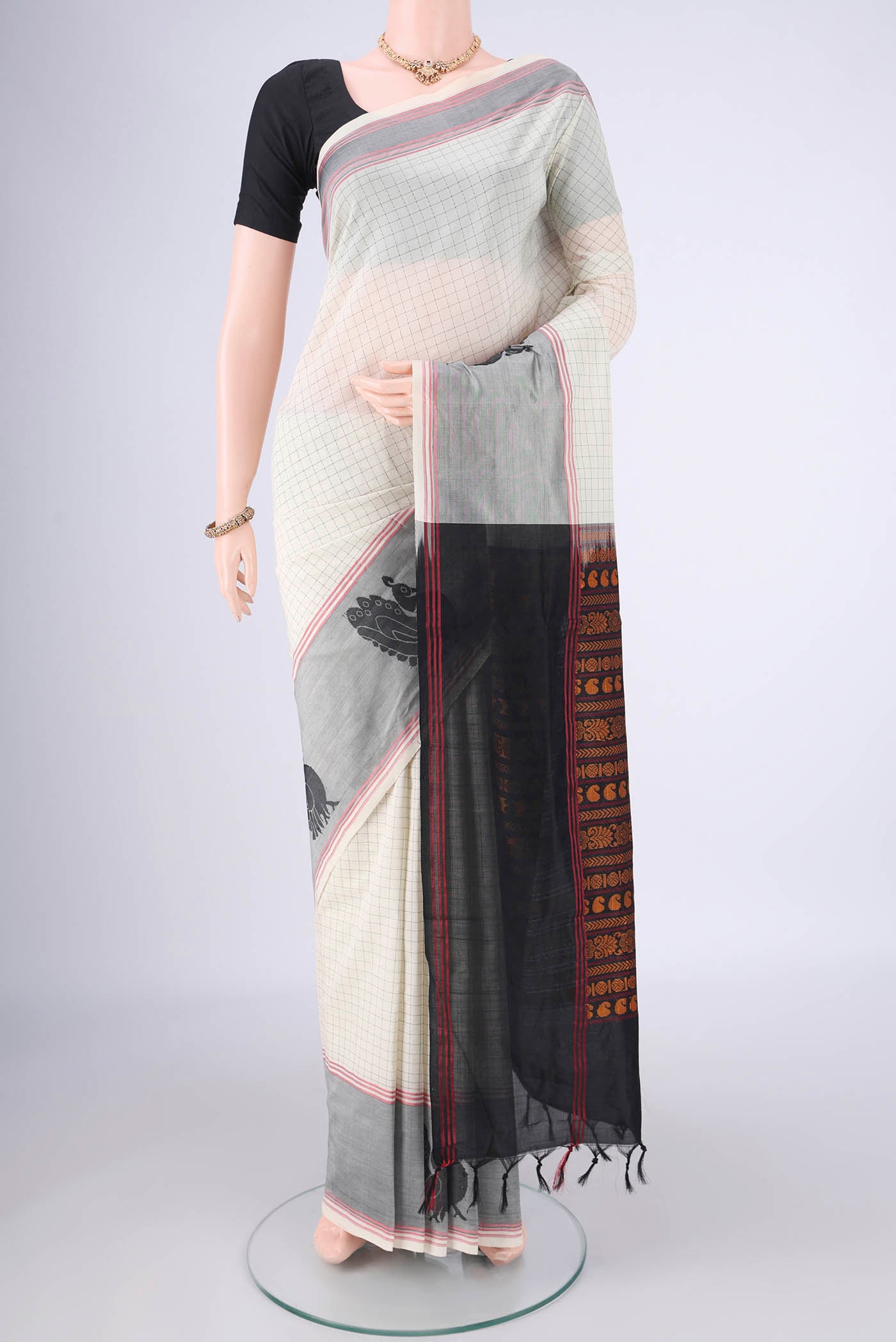 Off White Blended Poly Cotton Saree with Checked design on the body and Thread Border.  displayed on a mannequin