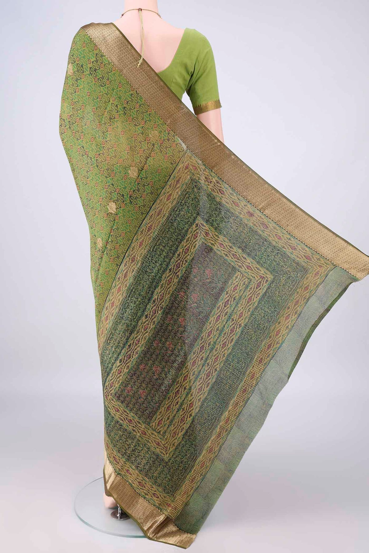 Flat view of Green Mysore Crepe Saree with Printed design on the body and Zari Border. 