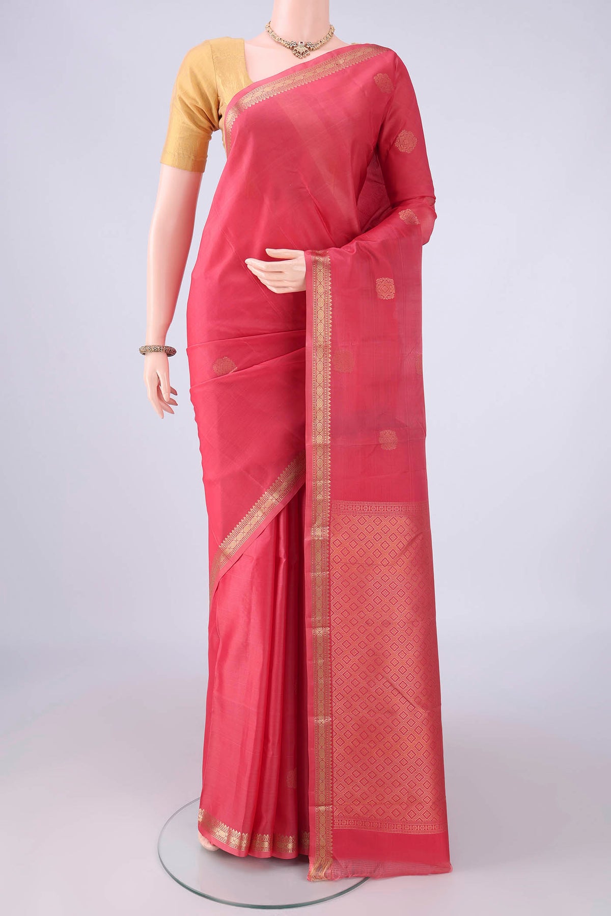 Coral Dual Tone Kanjivaram Silk Saree with Zari Butta on the body and Zari Border.  displayed on a mannequin