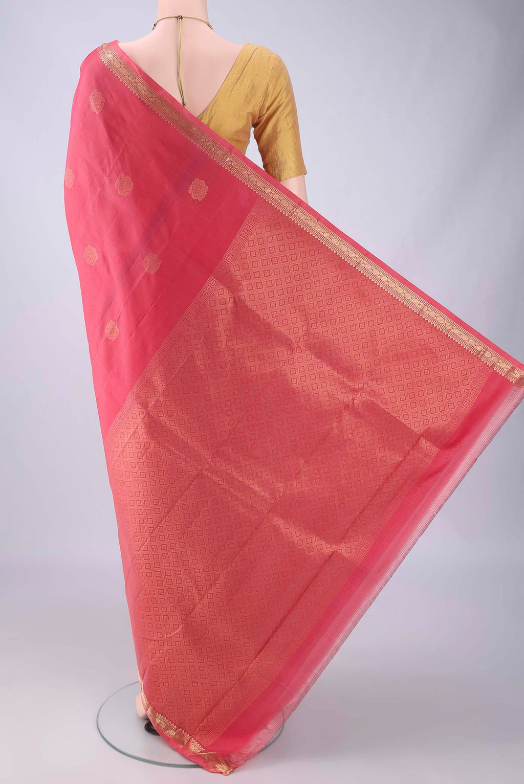 Flat view of Coral Dual Tone Kanjivaram Silk Saree with Zari Butta on the body and Zari Border. 