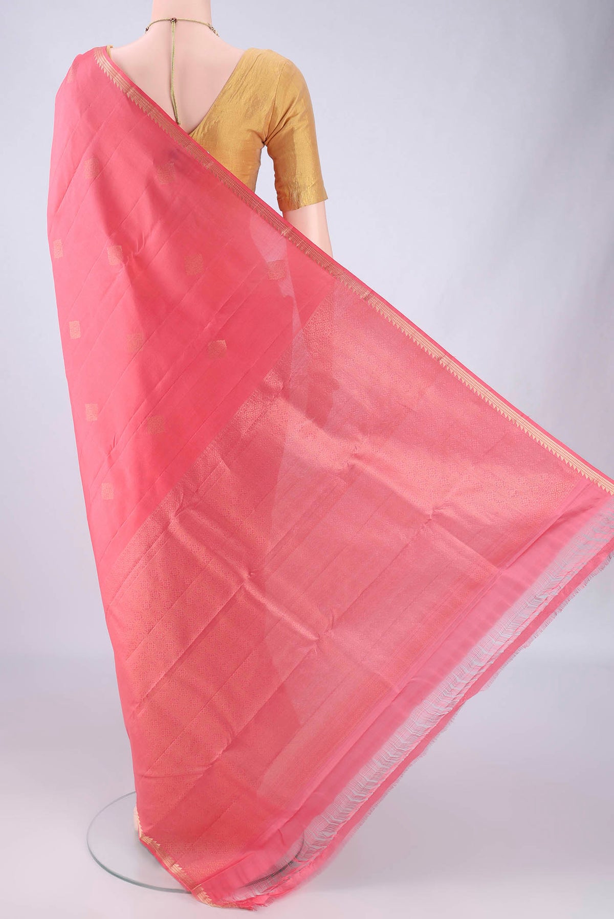 Flat view of Coral Kanjivaram Silk Saree with Zari Butta on the body and Zari Border. 