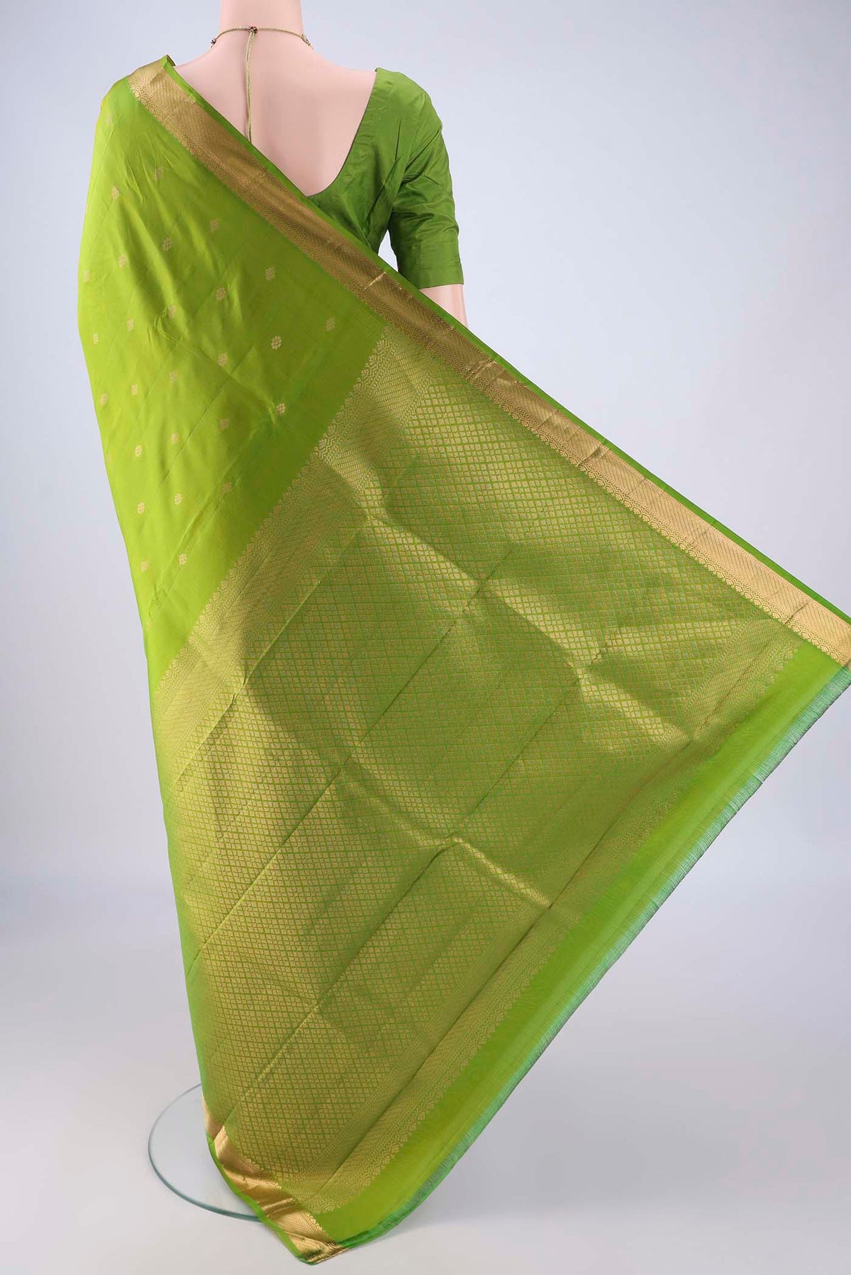 Flat view of Light Green Kanjivaram Silk Saree with Zari Butta on the body and Zari Border. 
