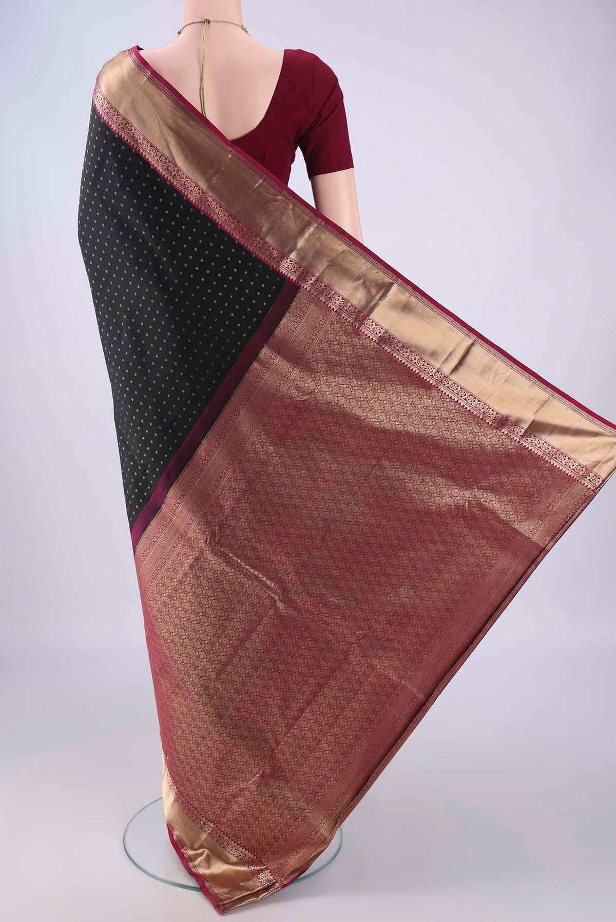 Flat view of Black Kanchipuram Silk Saree with Zari Butta on the body and Zari Border. 