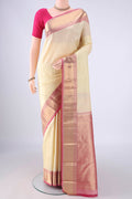 Cream Kanchipuram Silk Saree with Zari Butta on the body and Zari Border.  displayed on a mannequin