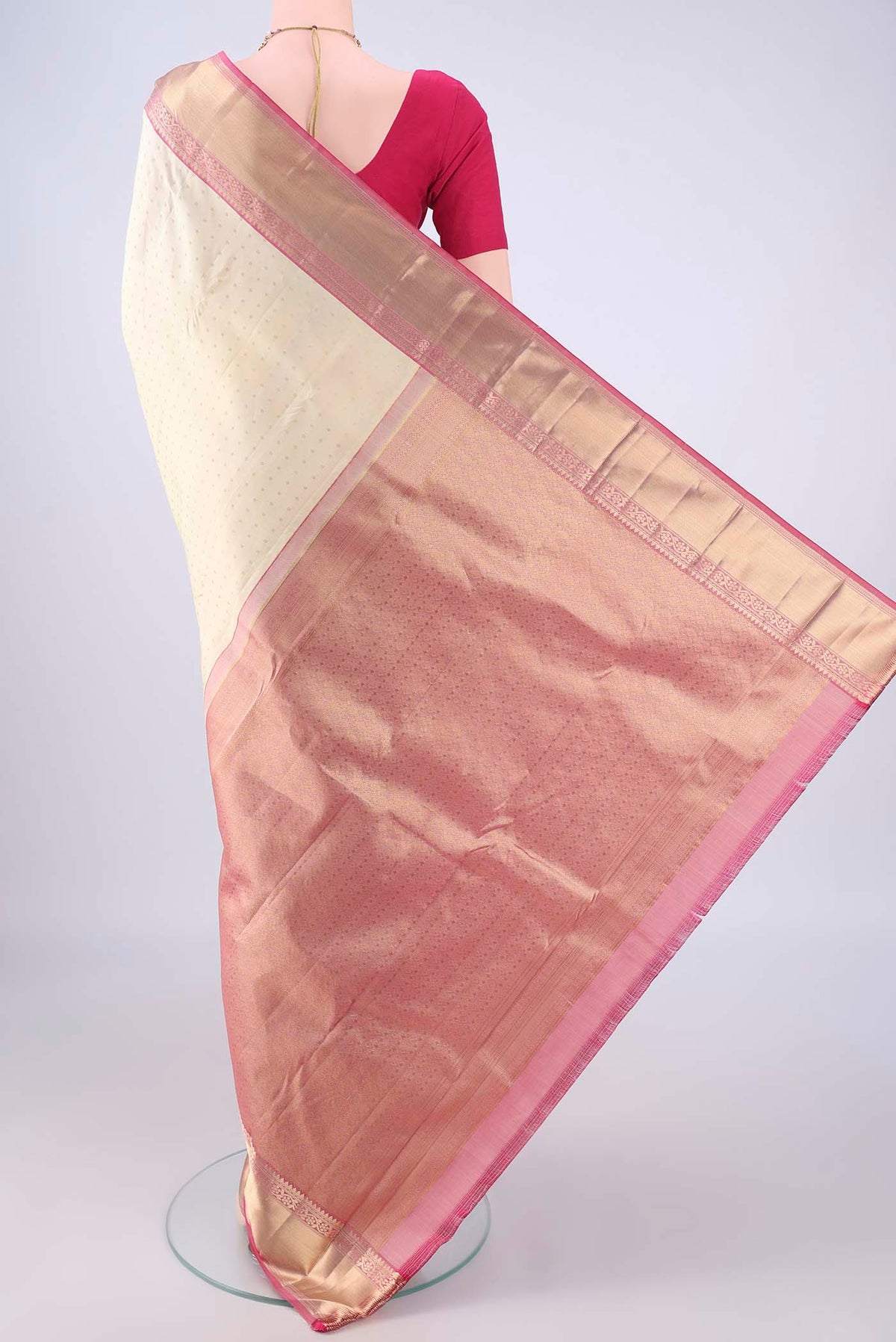 Flat view of Cream Kanchipuram Silk Saree with Zari Butta on the body and Zari Border. 