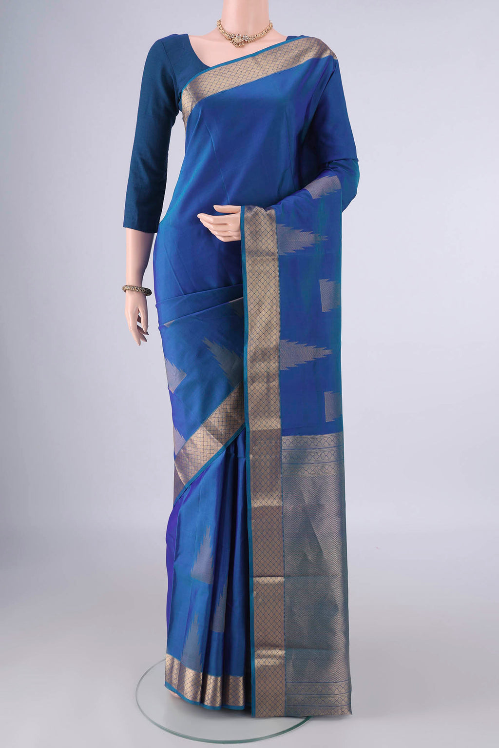 Pure Silk Blue Dual Tone Kanchipuram Saree with Zari Butta on the body and Zari Border.  displayed on a mannequin