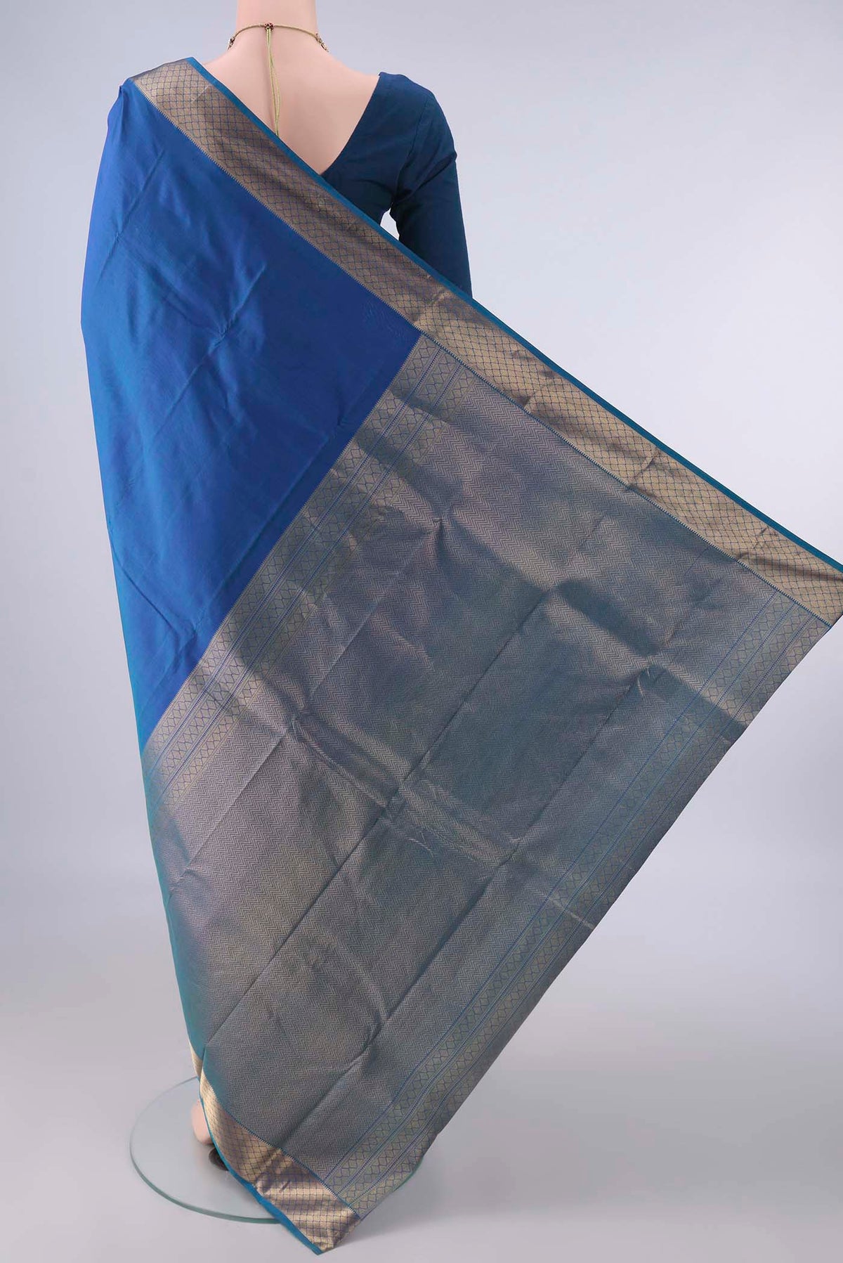 Flat view of Pure Silk Blue Dual Tone Kanchipuram Saree with Zari Butta on the body and Zari Border. 