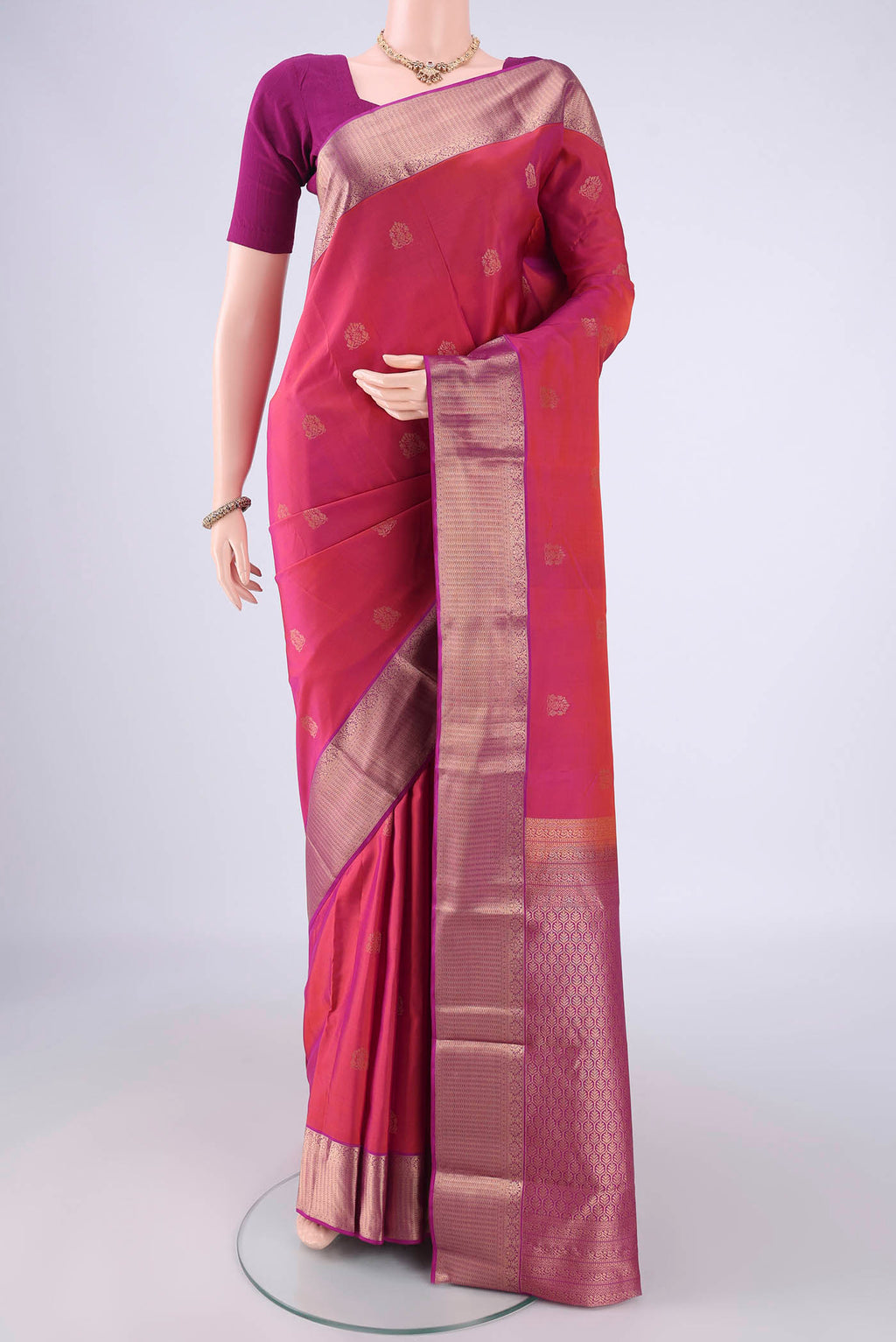 Pink Kanchipuram Silk Saree with Zari Butta on the body and Zari Border.  displayed on a mannequin