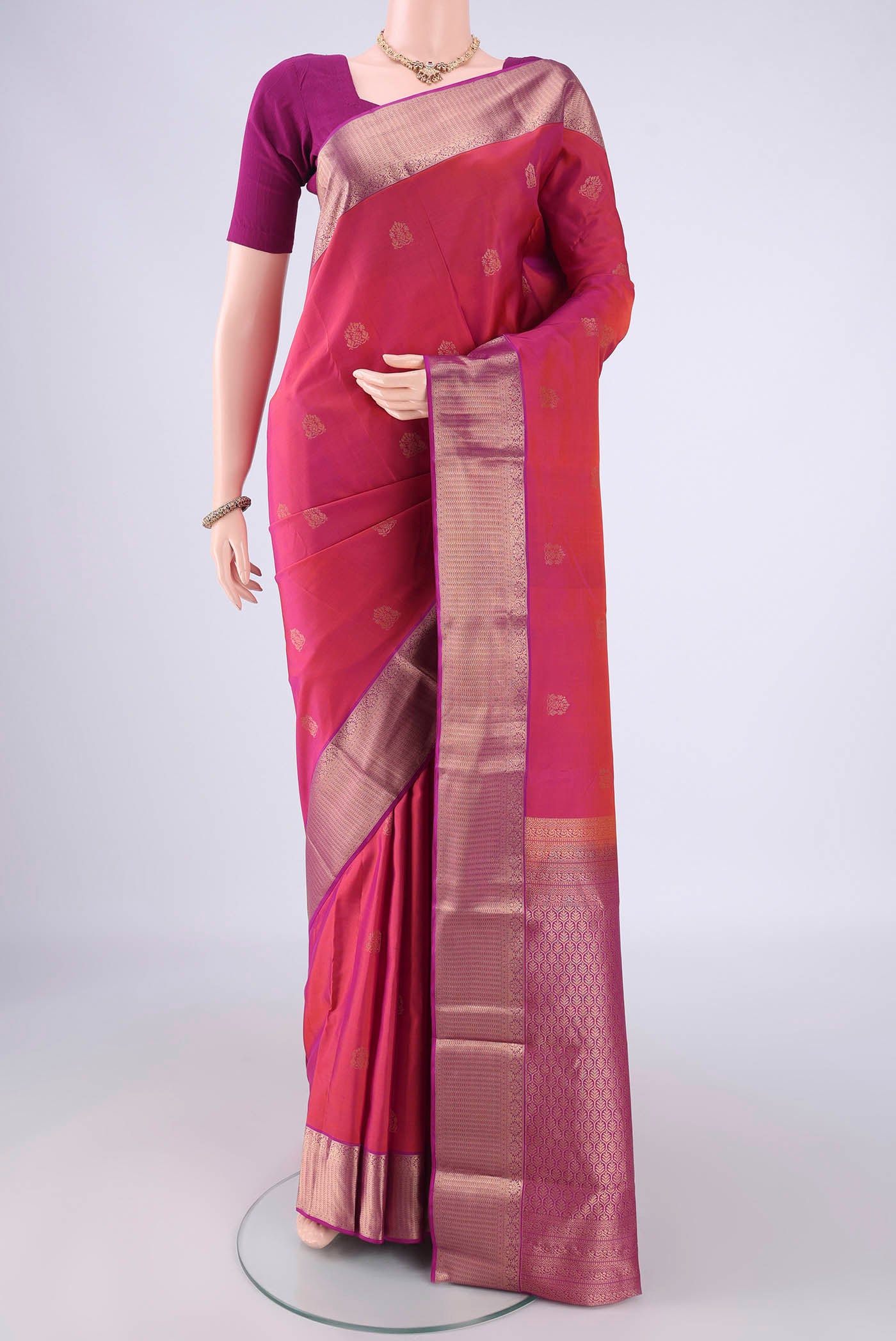 Pink Kanchipuram Silk Saree with Zari Butta on the body and Zari Border.  displayed on a mannequin