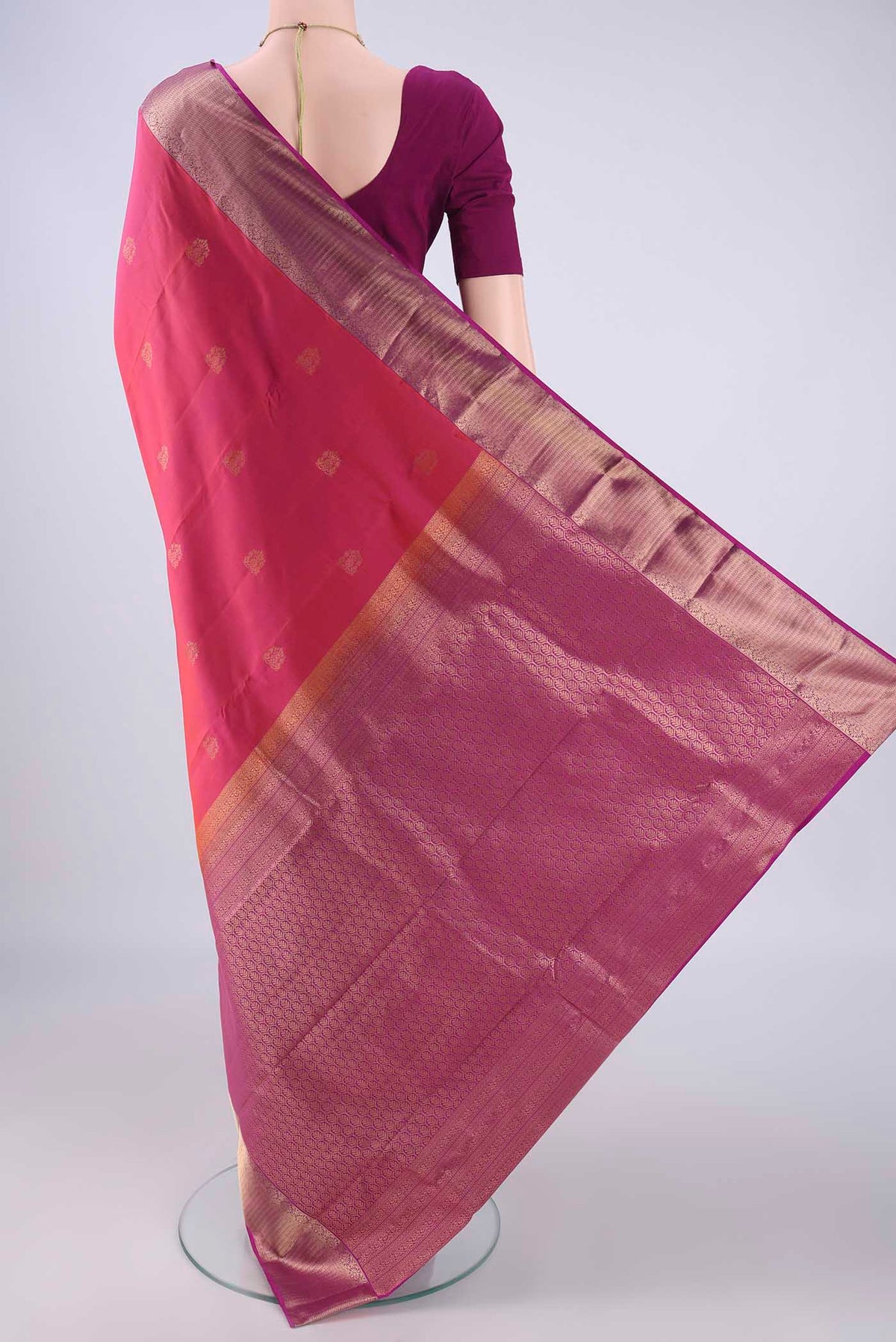 Flat view of Pink Kanchipuram Silk Saree with Zari Butta on the body and Zari Border. 