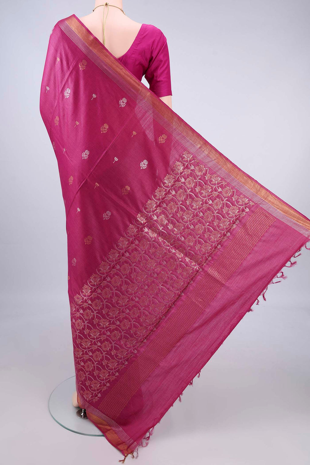 Flat view of Dark Pink Tussar Saree with Zari Butta on the body and Zari Border. 
