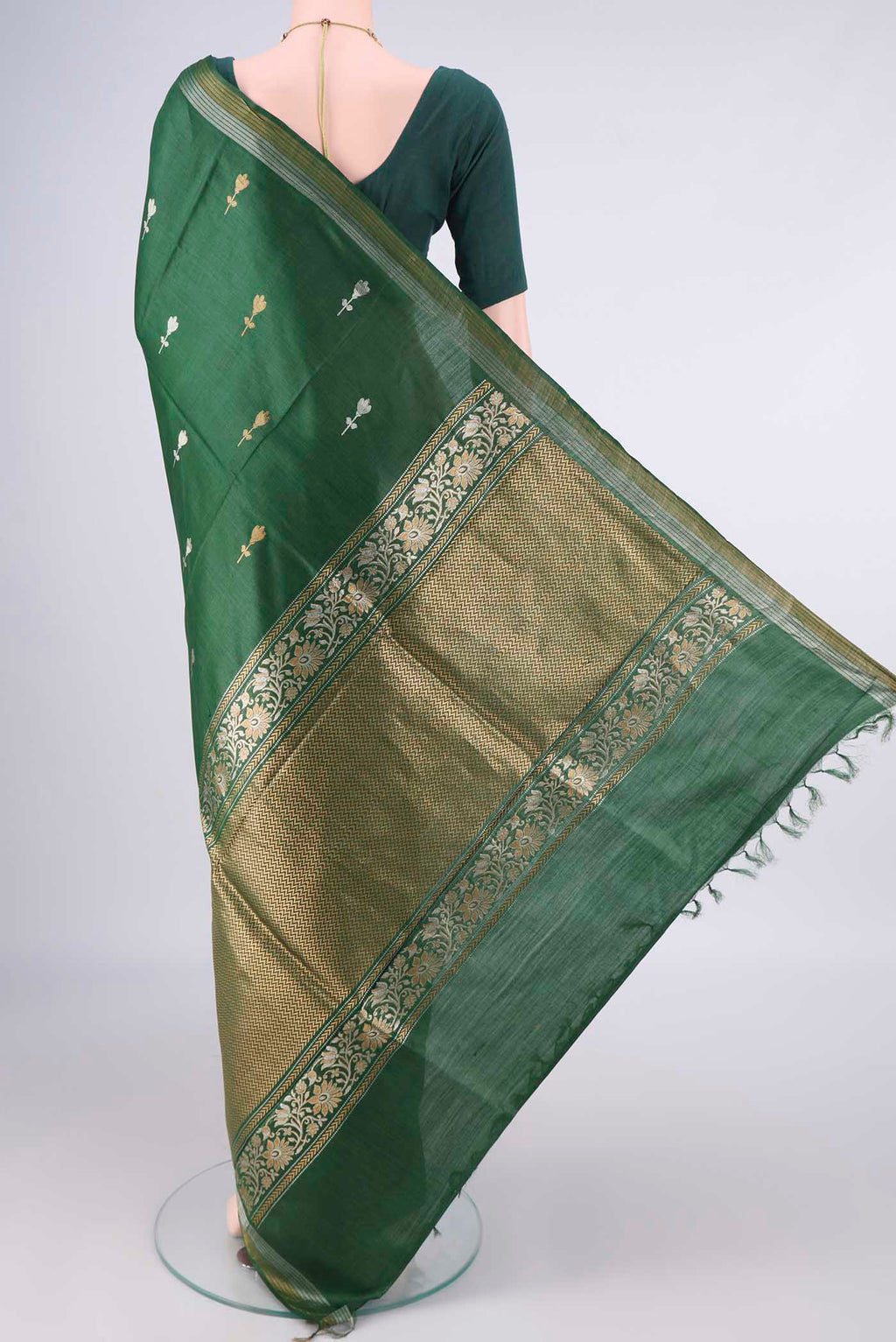 Flat view of Bottle Green MP Tussar Saree with Zari Butta on the body and Zari Border. 